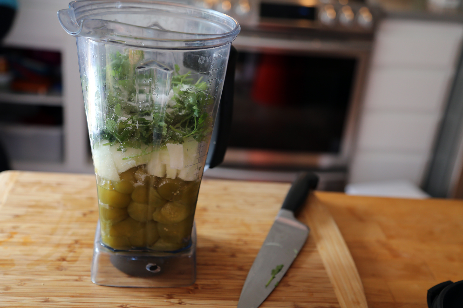 To make the sauce, add the tomatillos, garlic, chiles if using, cilantro, onion, and 1 tsp salt, to a blender.