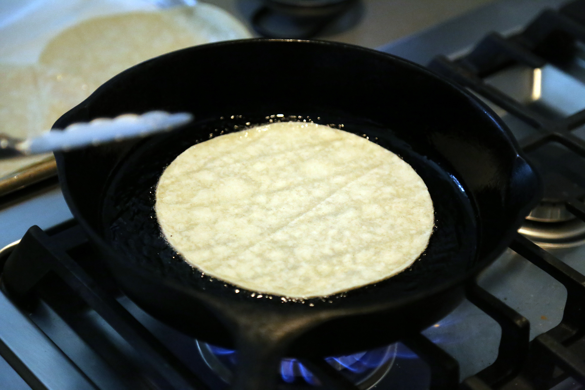 Fry the tortillas, turning them after a few seconds.