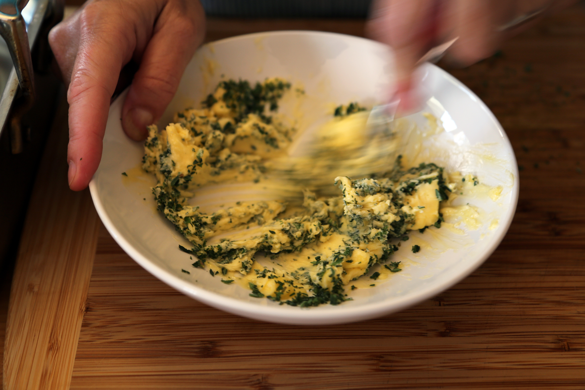 In a bowl, stir together the butter, thyme, and sage until well combined.