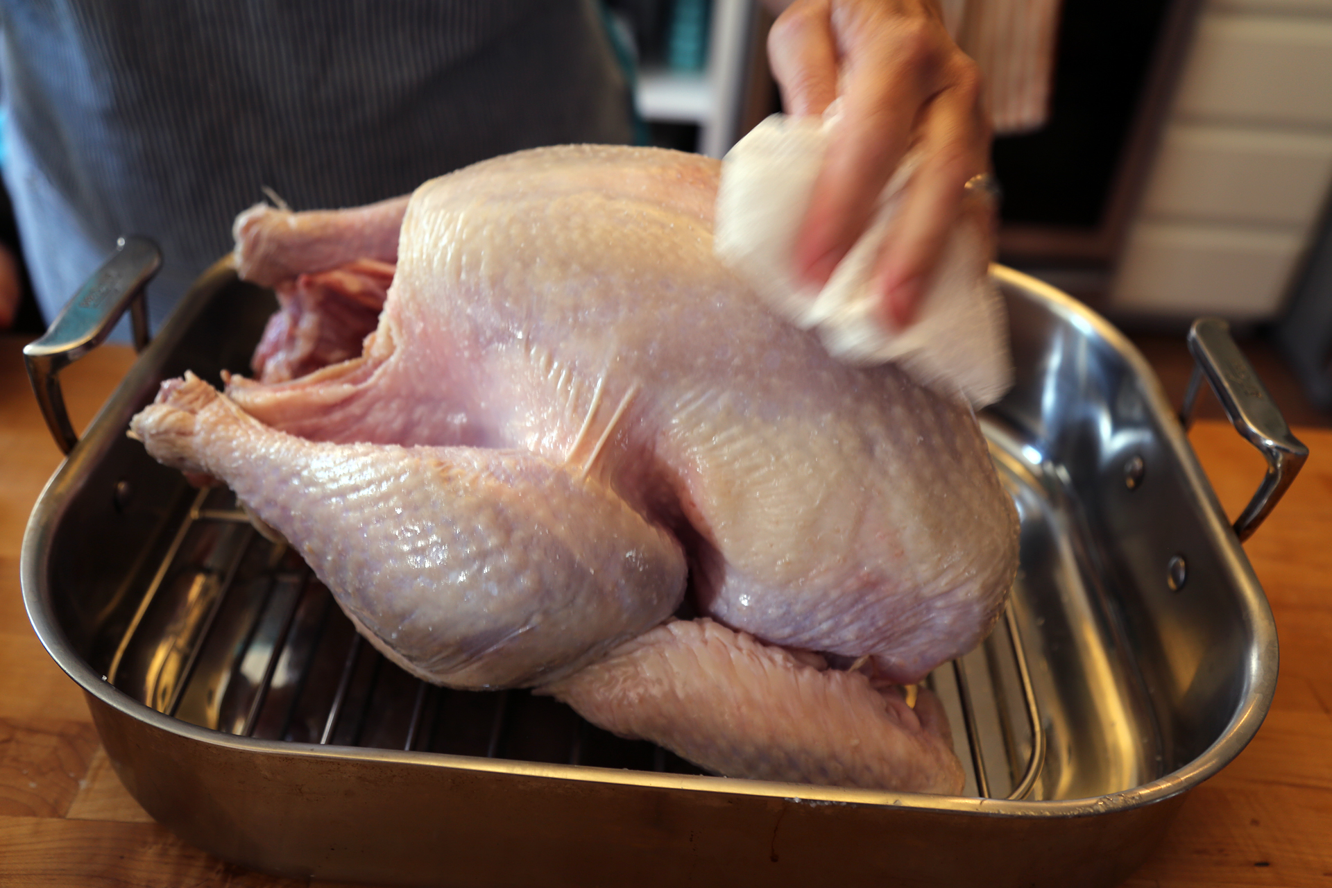 Take the chill off the turkey and dry it all over with paper towels.