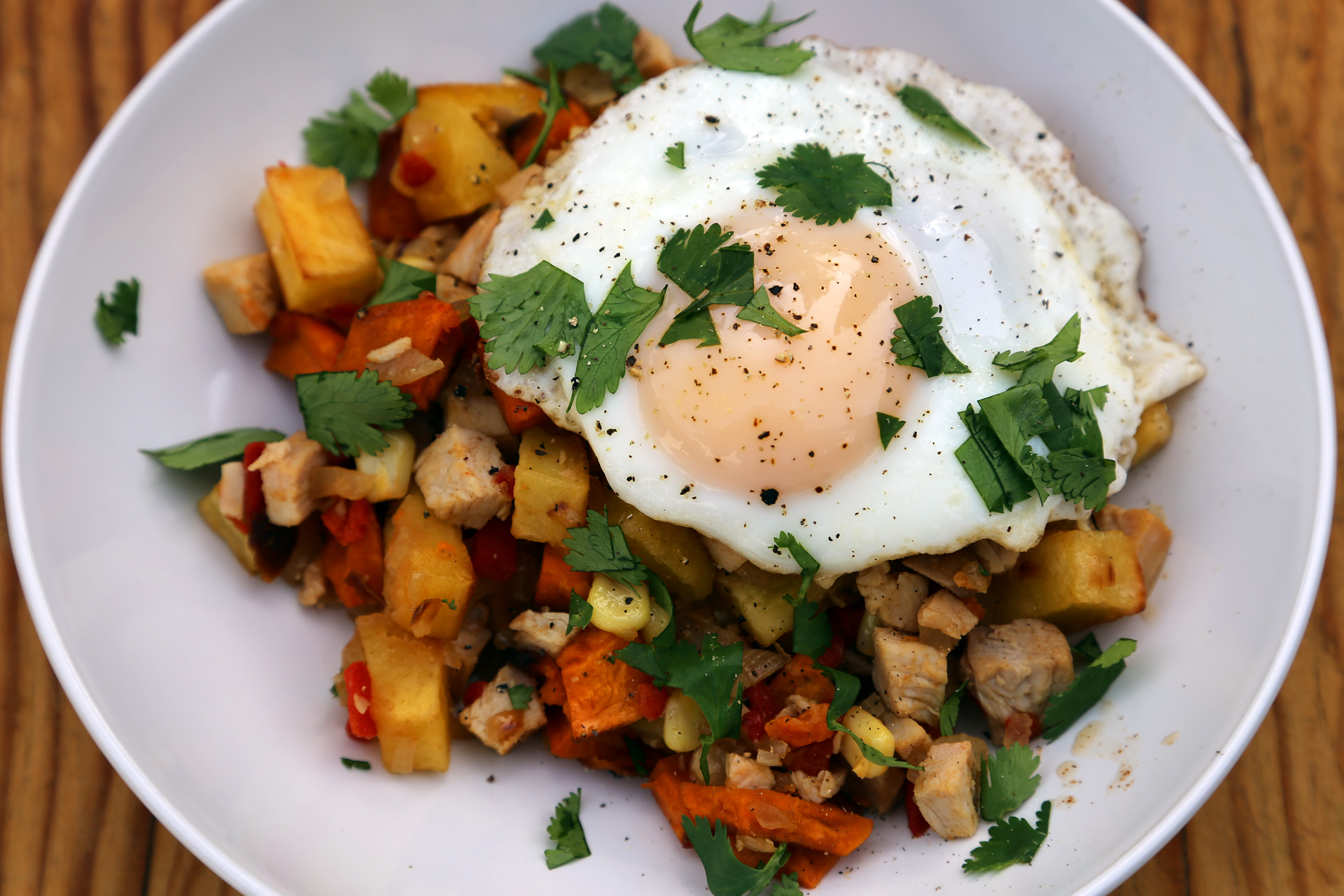 Morning-After Turkey Breakfast Hash with Sweet Potatoes and Roasted Peppers (and a fried egg!).
