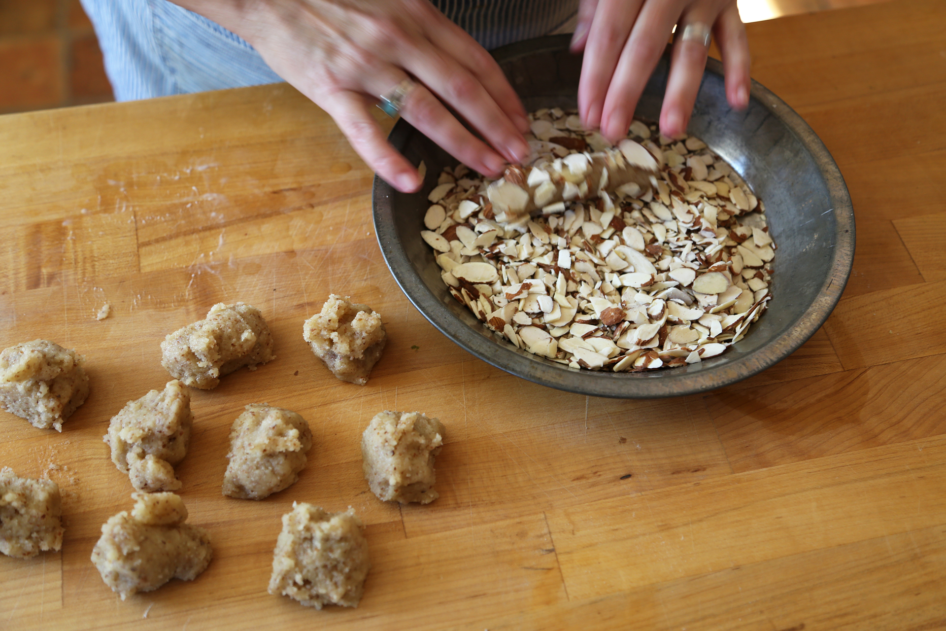 Roll the logs into the crushed sliced almonds.
