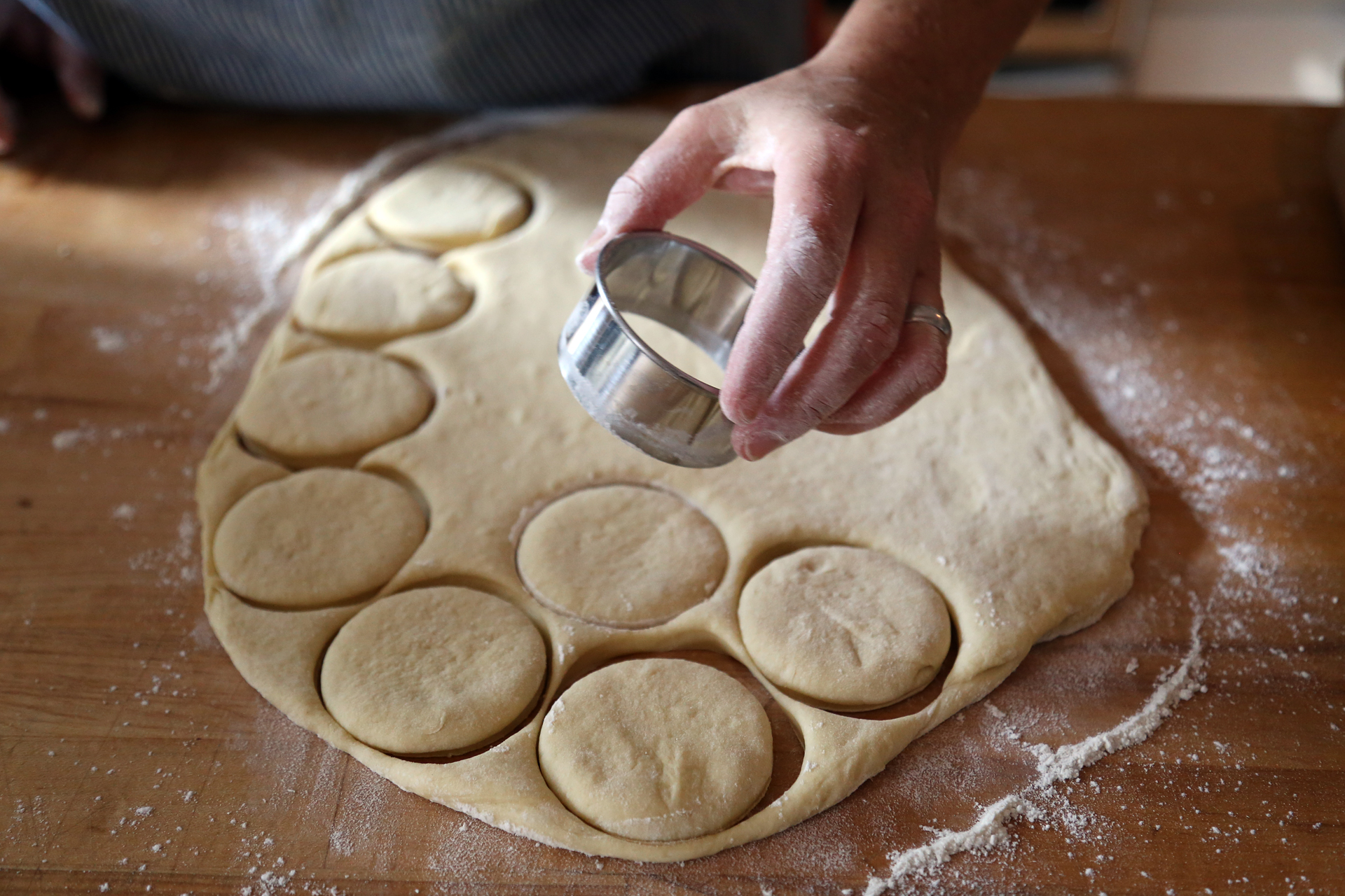 With a 2-inch round biscuit or cookie cutter, cut out as many rounds of dough as you can. 