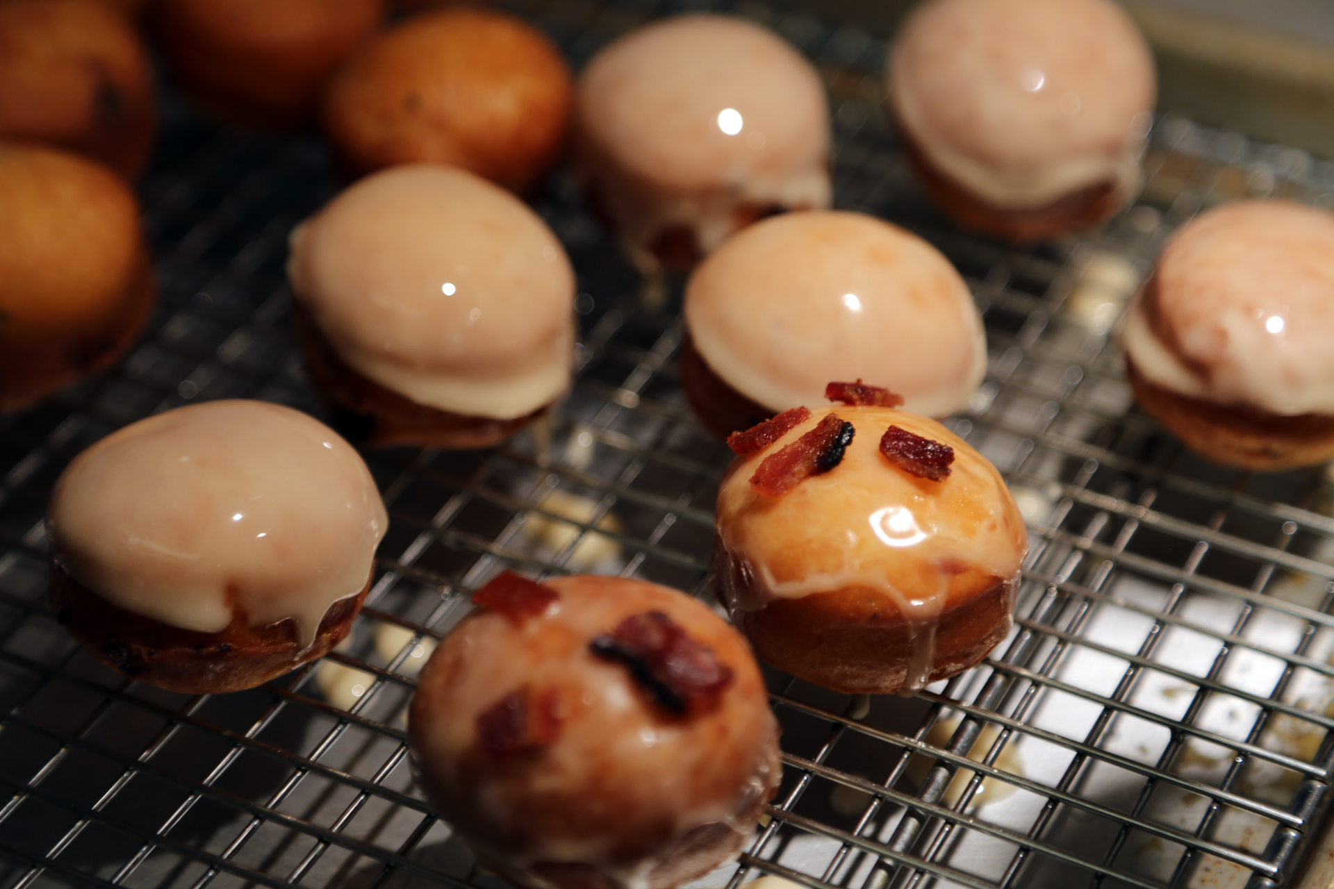 While the donuts are still warm, dip them into the glaze. Let the excess glaze drip off, and place on a wire rack set over a baking sheet. 