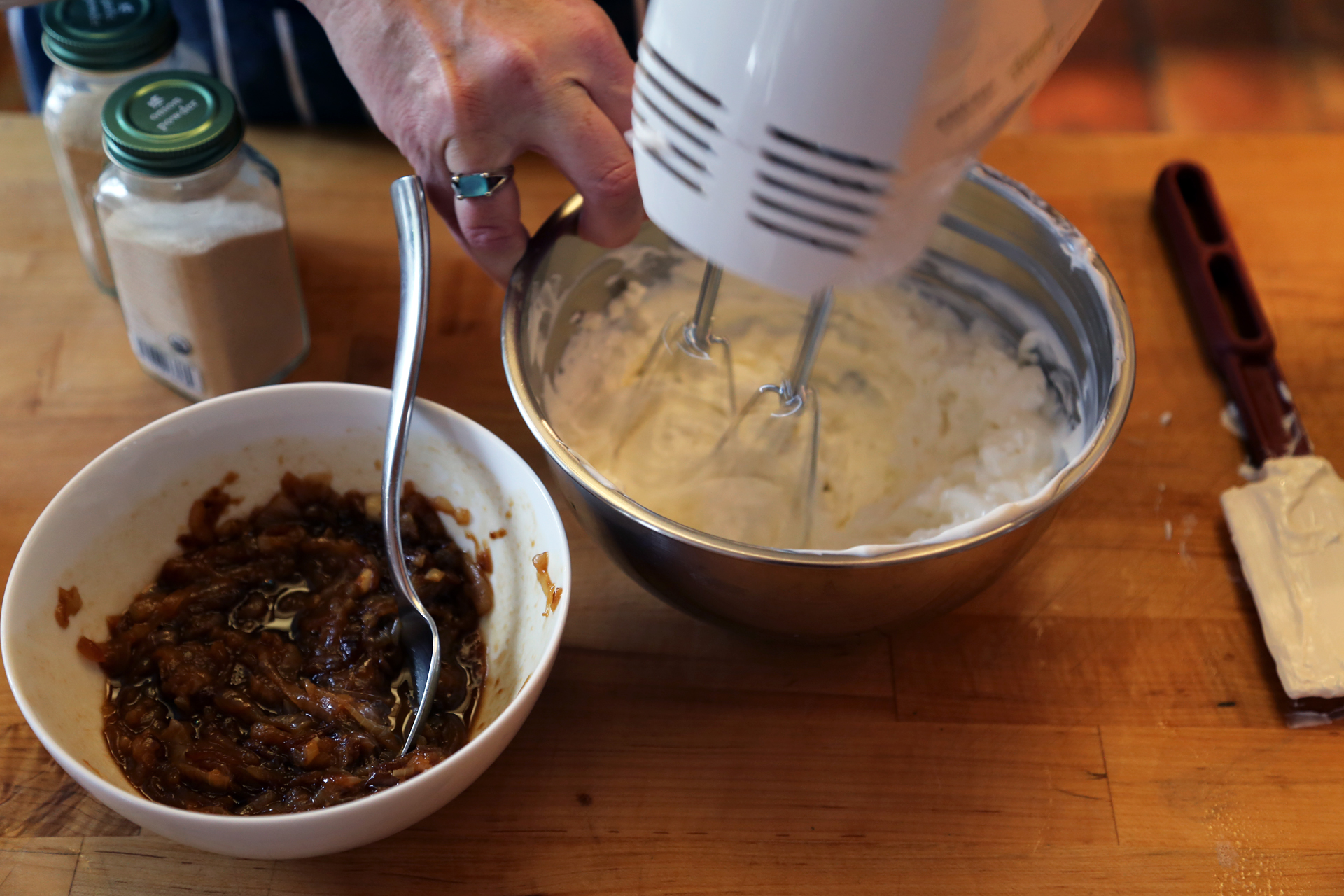 Add the sour cream and cream cheese to a mixing bowl and beat with an electric hand mixer or a wooden spoon until smooth and well combined.