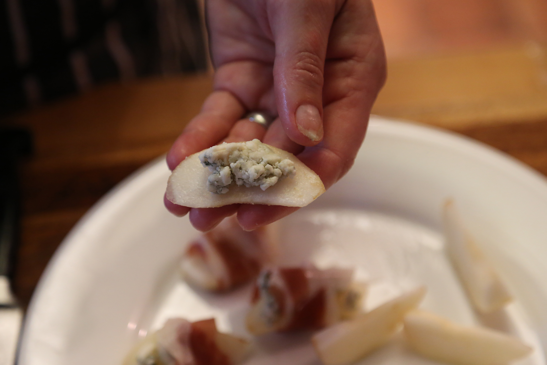 On each pear slice, press 1 tsp of blue cheese into a pile.