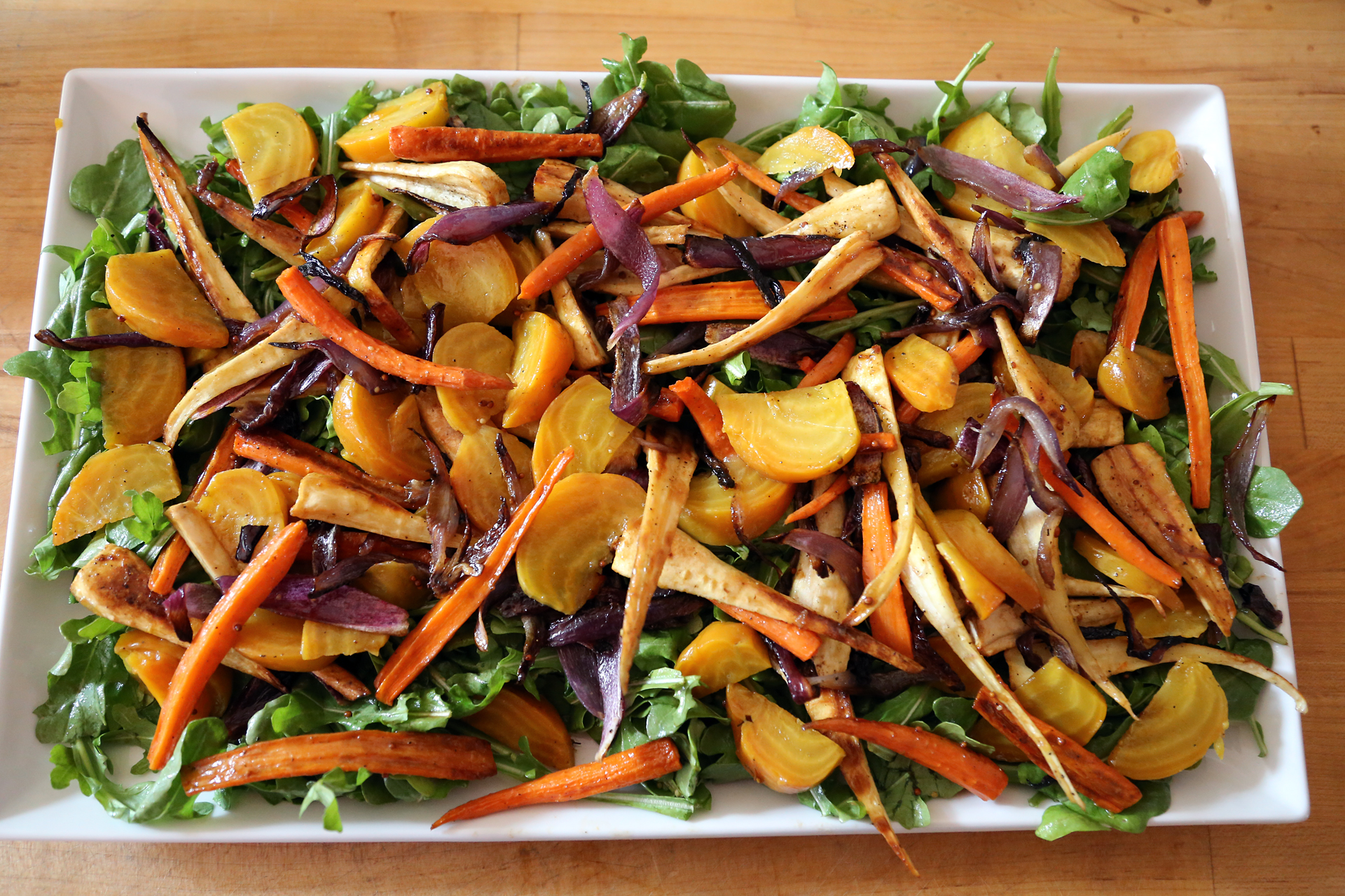 Top the arugula with the roasted vegetables.