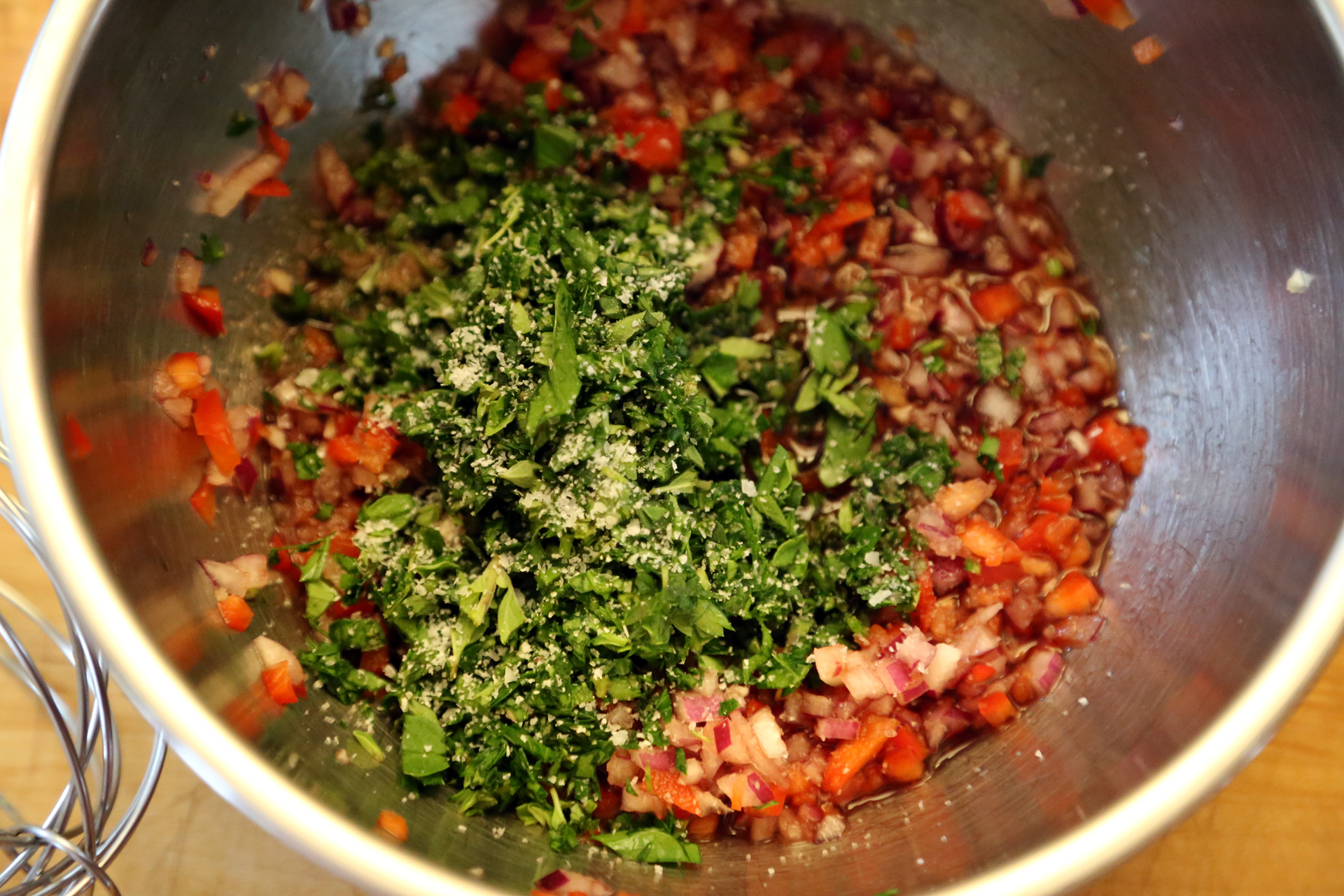 To make the chimichurri, in a mixing bowl, whisk together the vinegar, onion, garlic, bell pepper, parsley, oregano, and red pepper flakes to taste.