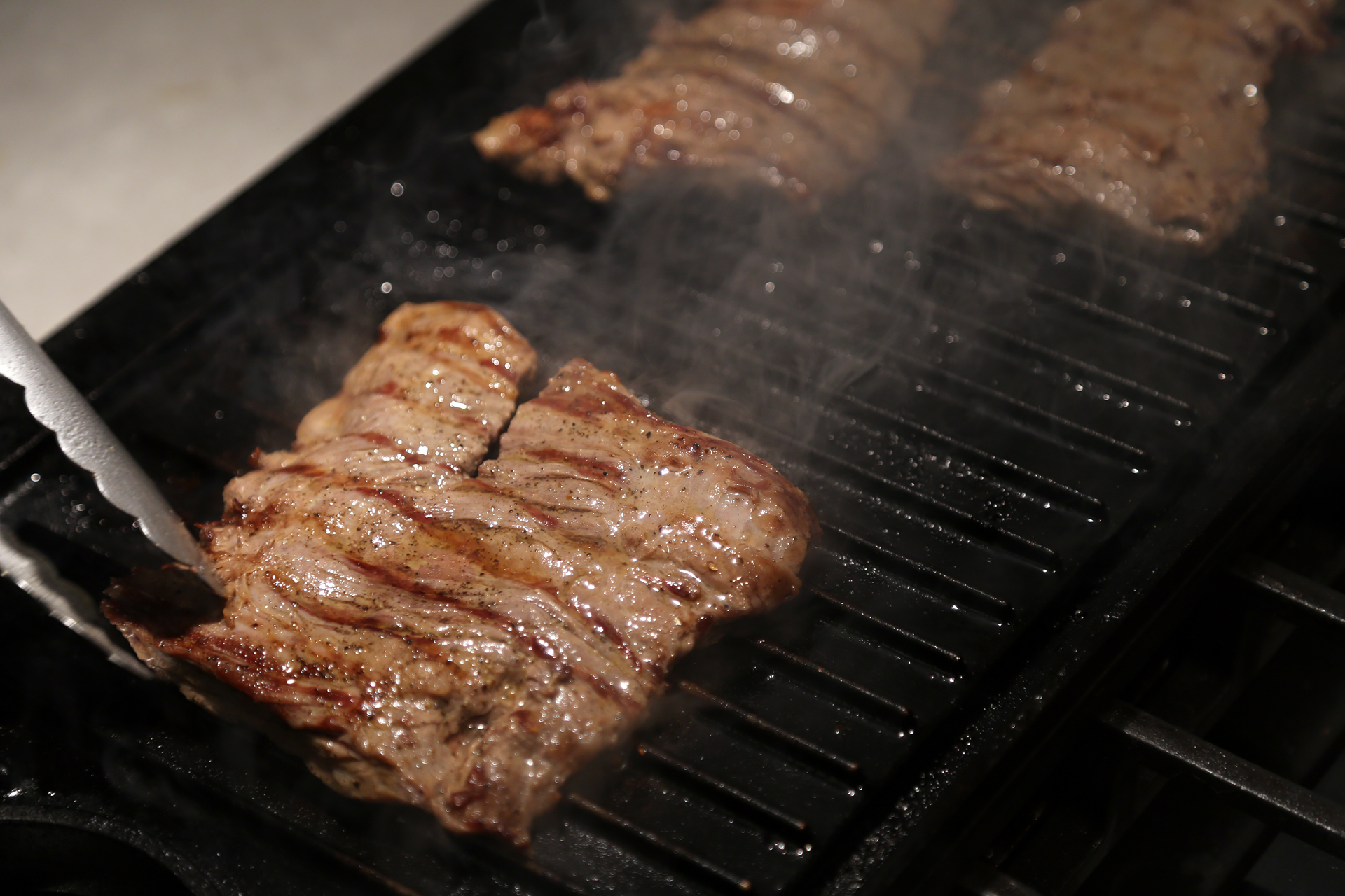 Brush the grill grate or stovetop grill with oil. Sear the steak, turning, until nicely seared on both sides and medium-rare. 