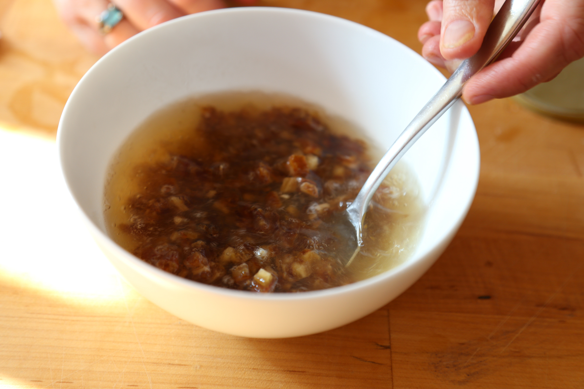 In a small bowl, combine the chopped dates and the baking soda with the boiling water, stirring to combine.