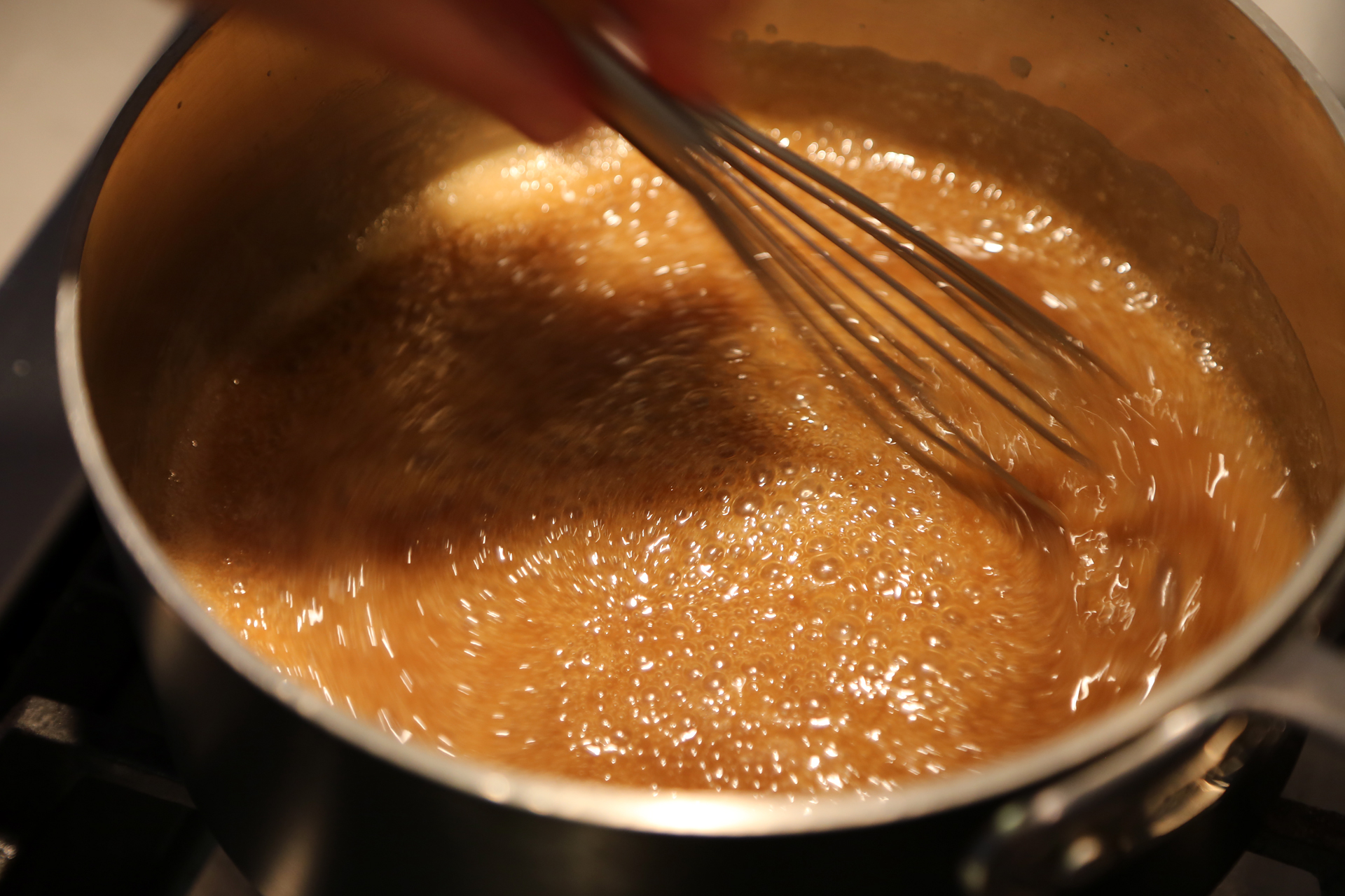  Simmer, stirring constantly with a whisk, until the sauce becomes sticky.