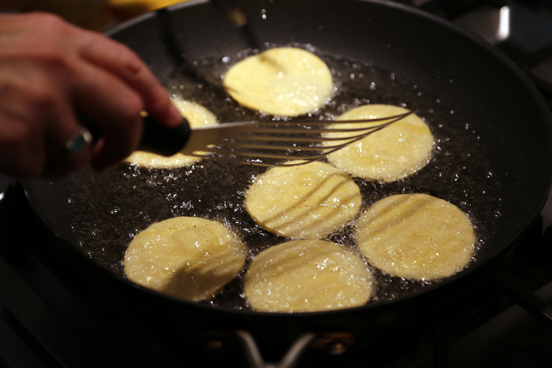 Warm about 1/2 inch of oil in a large frying pan over medium-high heat and then add the tortilla rounds.