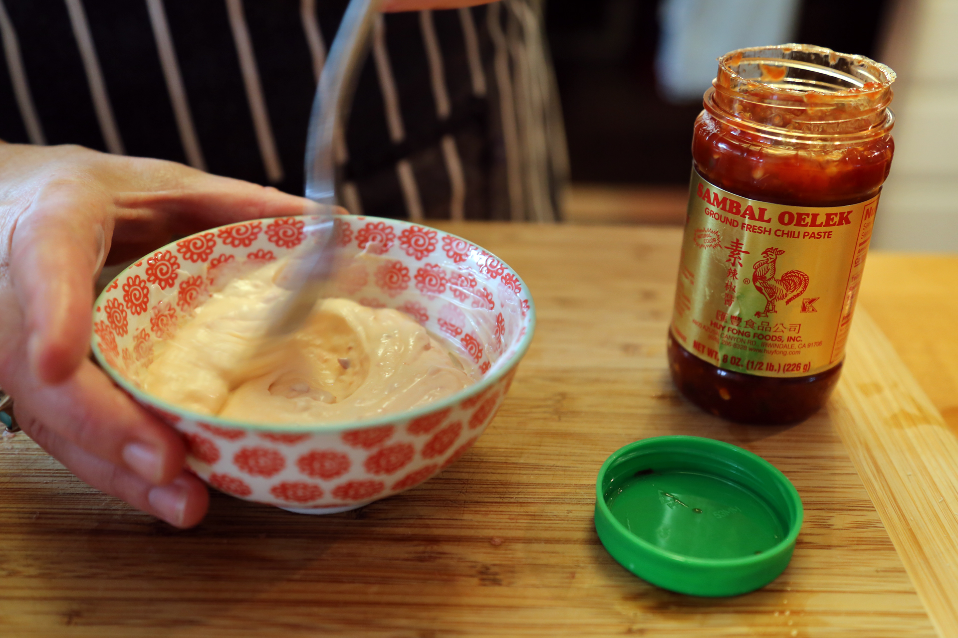 In another bowl, stir together the mayo and sambal oelek; cover and refrigerate.