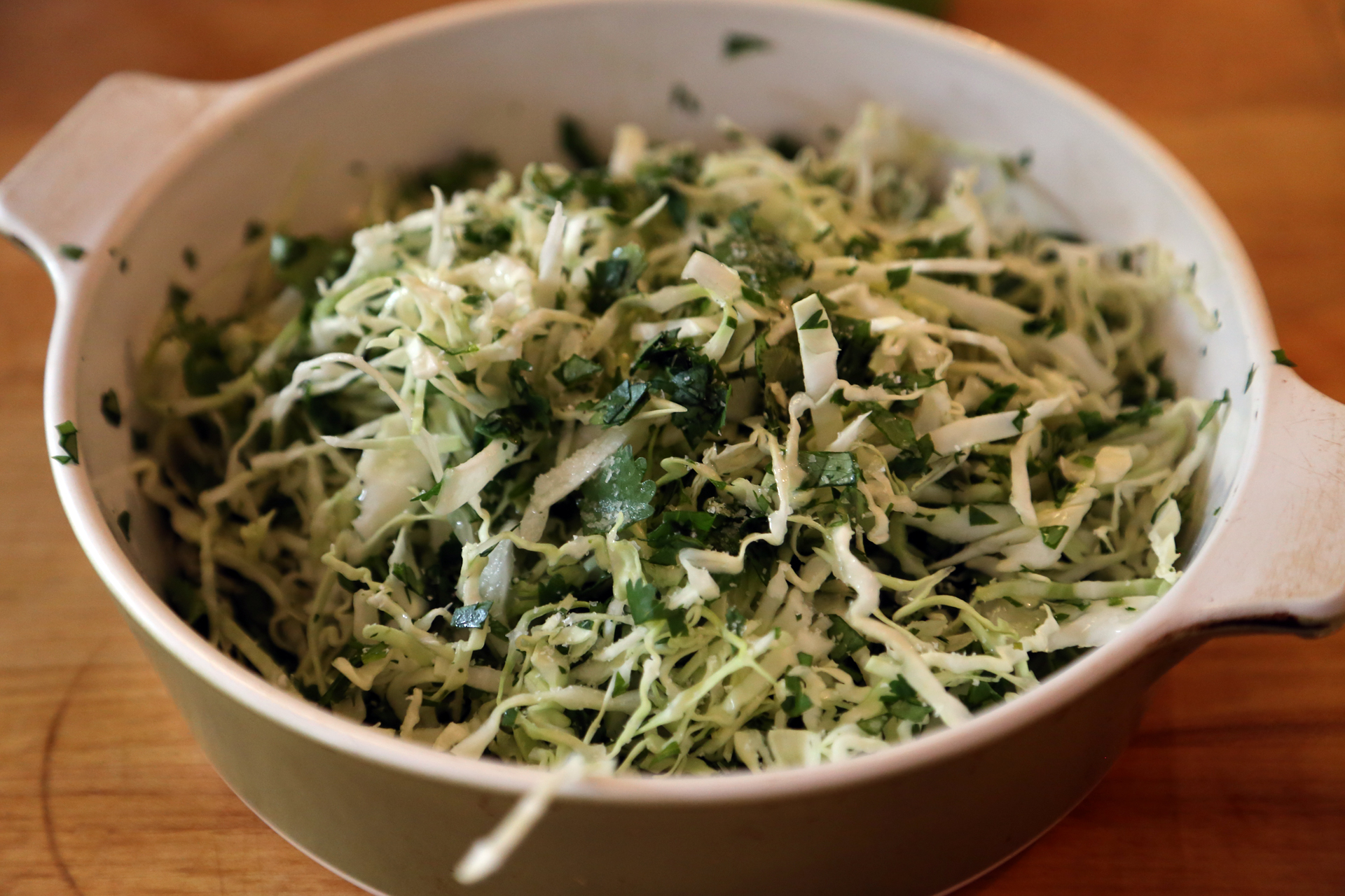 In a third bowl, stir together the cabbage and cilantro, then sprinkle with the vinegar and season with salt and pepper.
