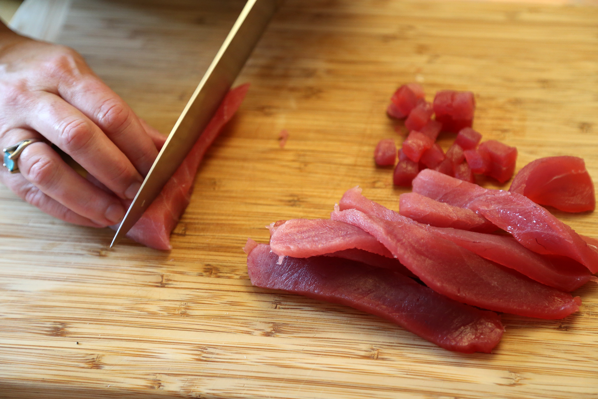 Cut the 1/2 lb raw sushi grade ahi into small cubes.