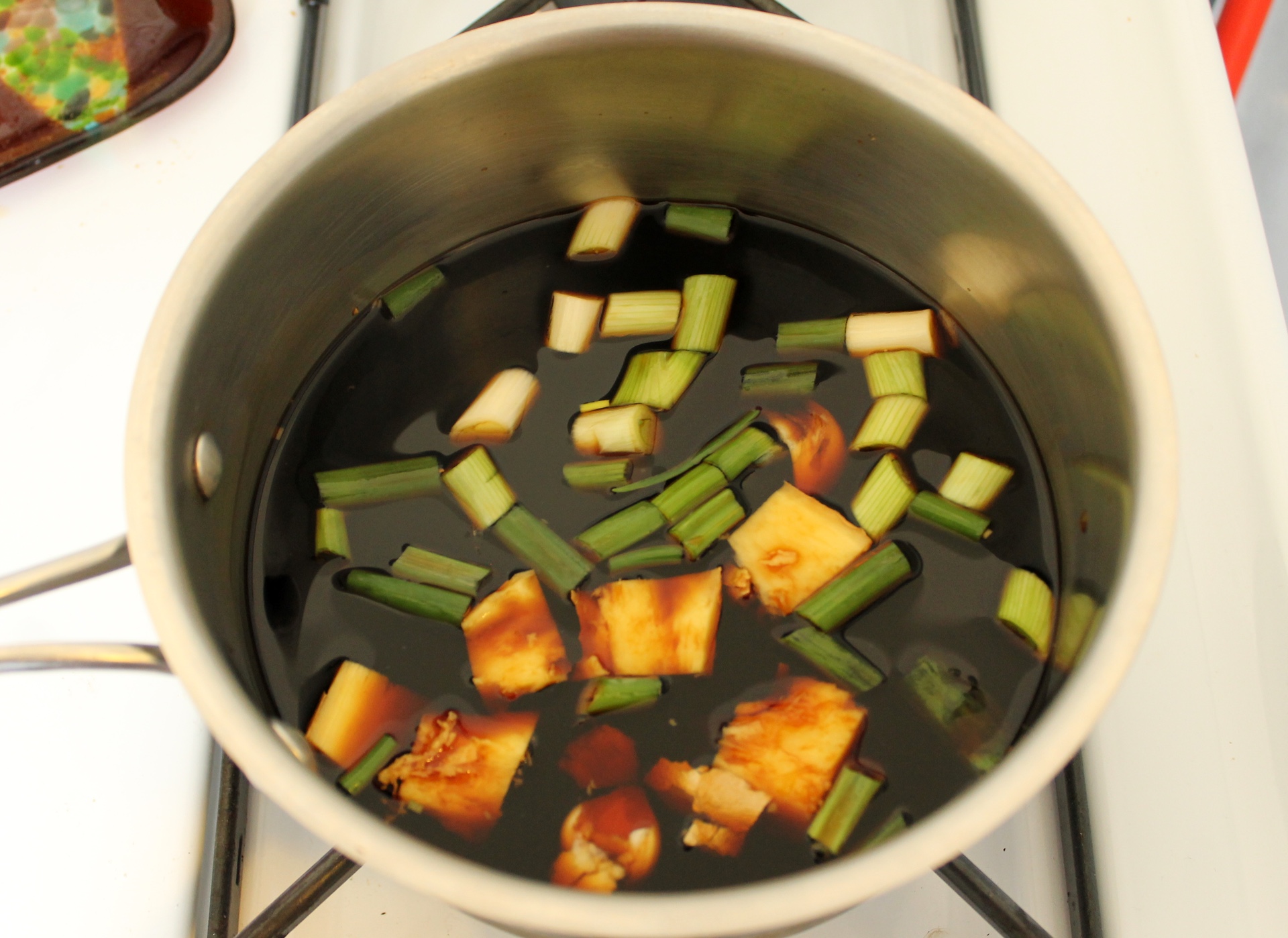 To make shoyu tare, combine soy sauce, sake, scallions, ginger, mirin, and garlic in a medium saucepan. Bring to a boil over high heat. Remove from the heat and let cool to room temperature. Strain and discard solids.