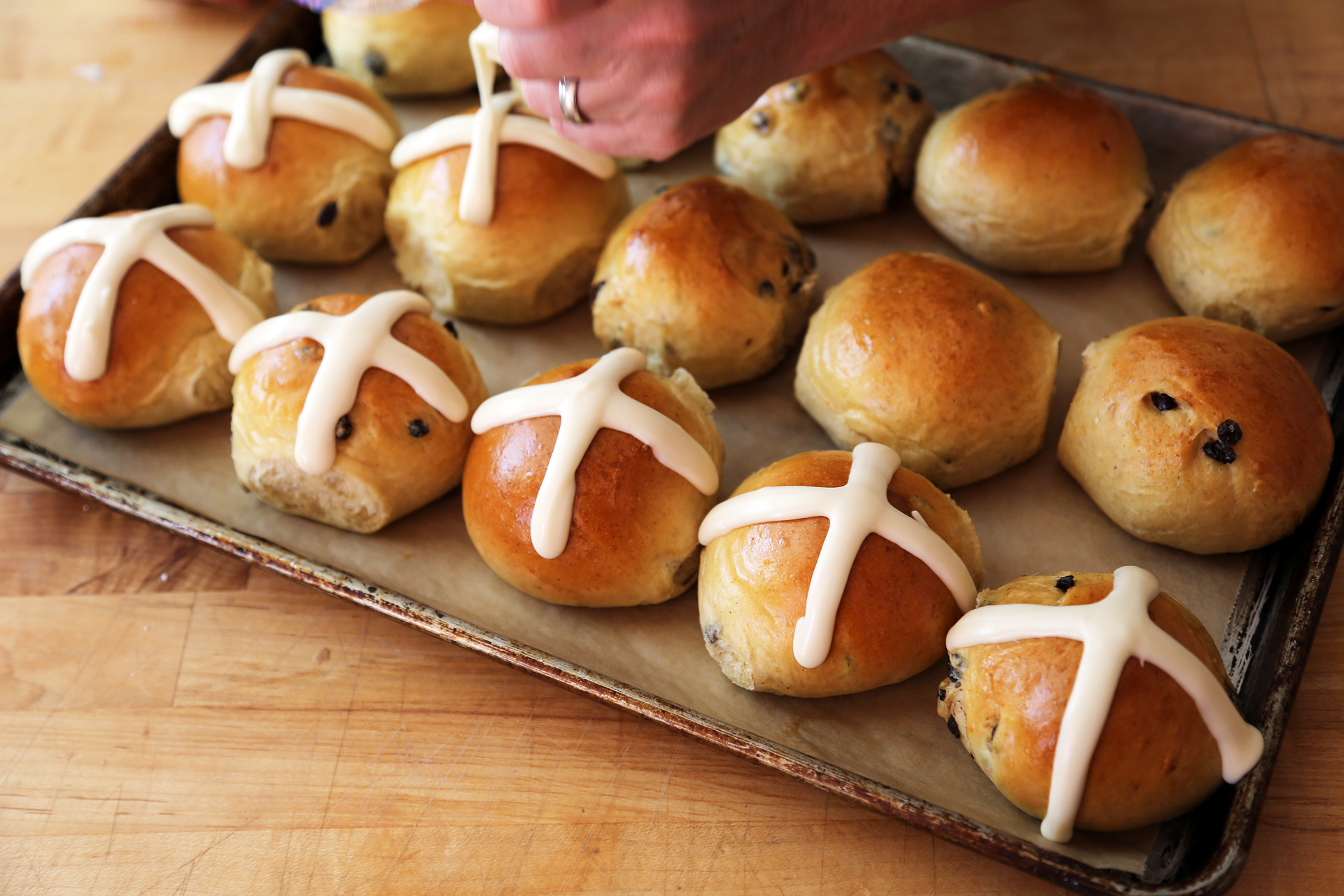 Traditionally the crosses are made with a flour paste piped on before baking. But I’m just not crazy about that and frankly, I like the sticky sweet icing.