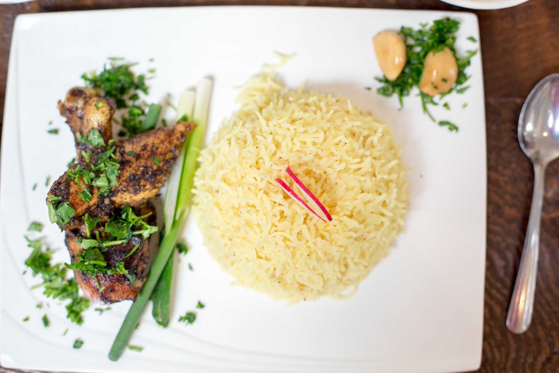 Komaaj serves turmeric rice with roasted chicken marinated in sour orange molasses, mountain cumin and Persian hogweed.