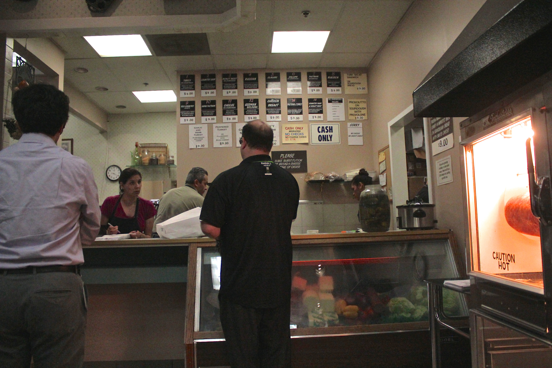Customers ordering at the counter of Freshly Baked Eatery.
