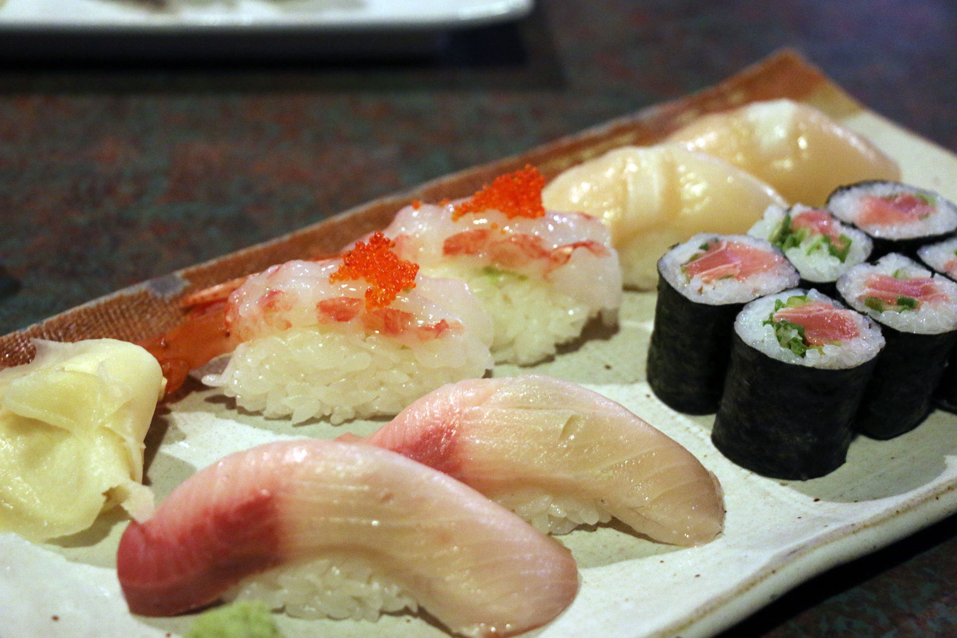  A selection of nigiri sushi and a negihama (yellowtail and scallion) roll.