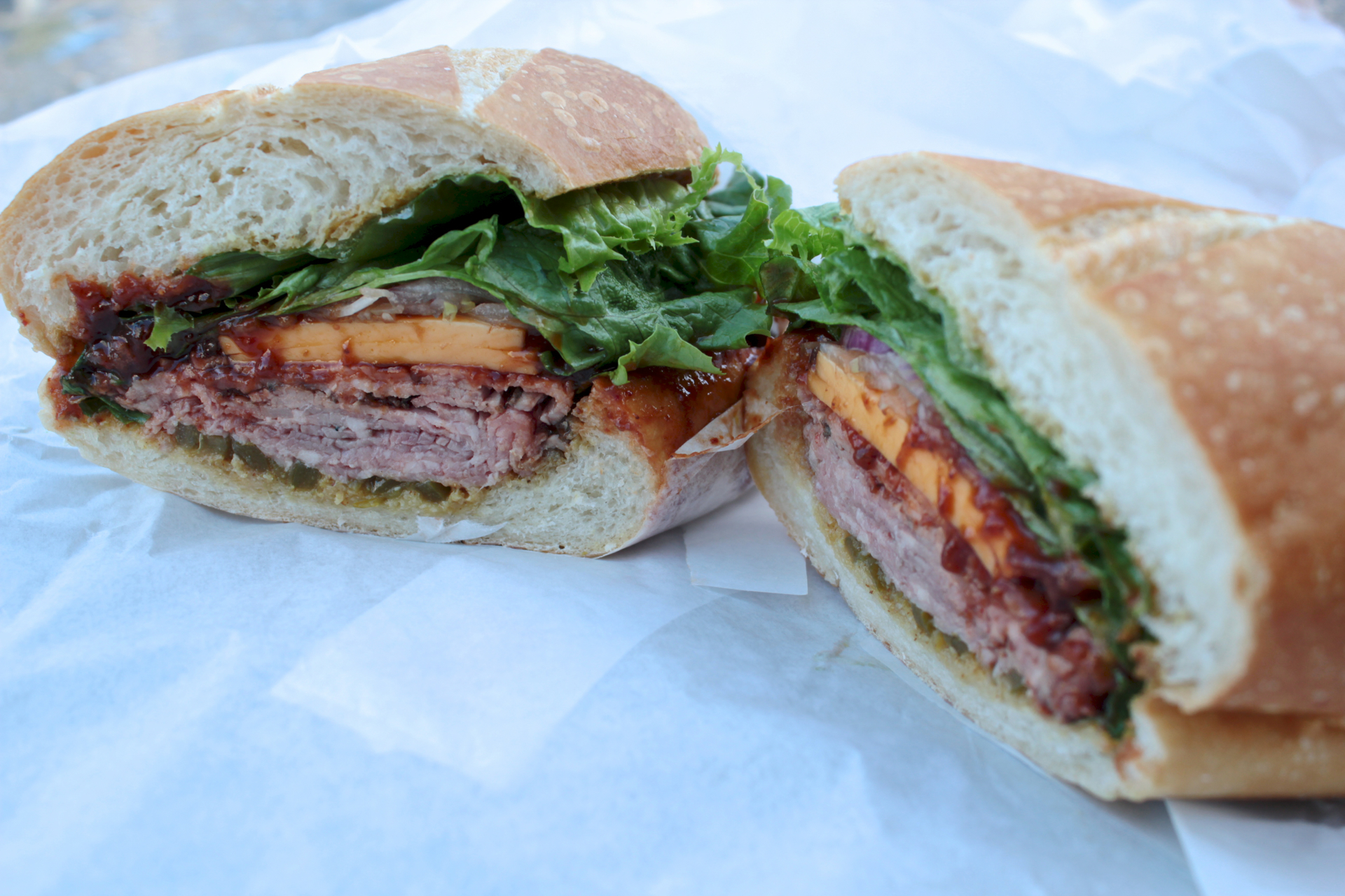 The Slow Burn sandwich features Tri-Tip with chipotle sauce, honey mustard and peppers.