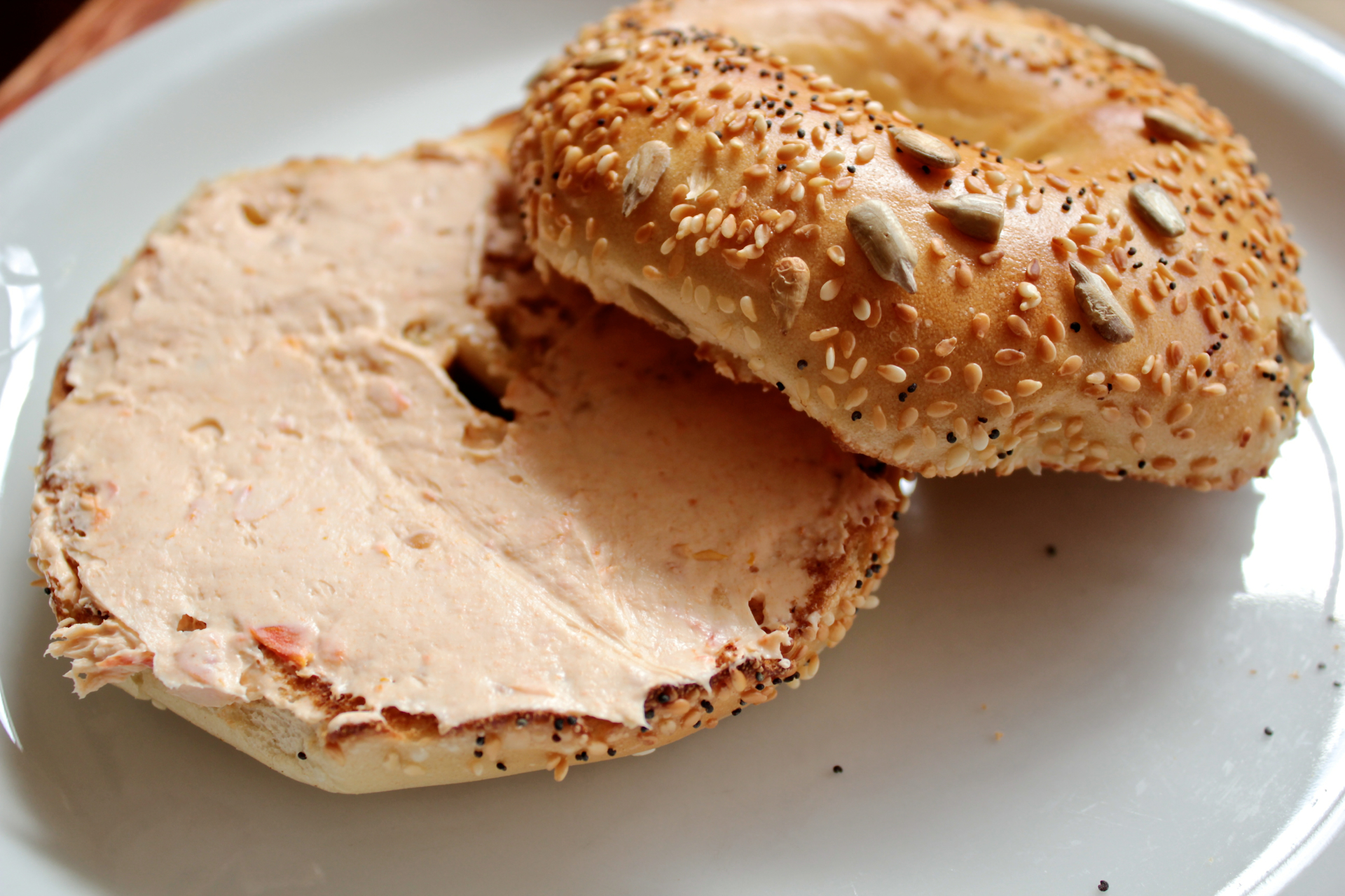 An everything bagel with sun-dried tomato spread.