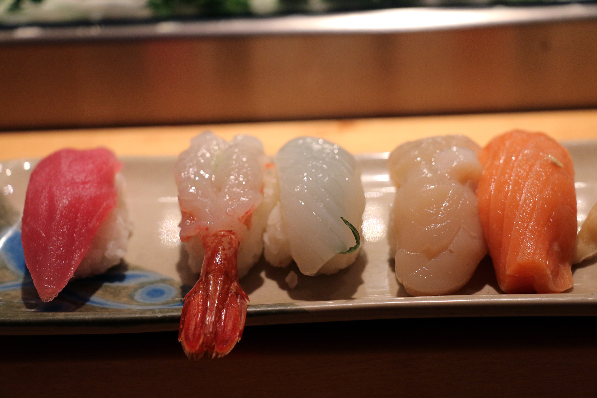 A selection of five types of nigiri sushi.