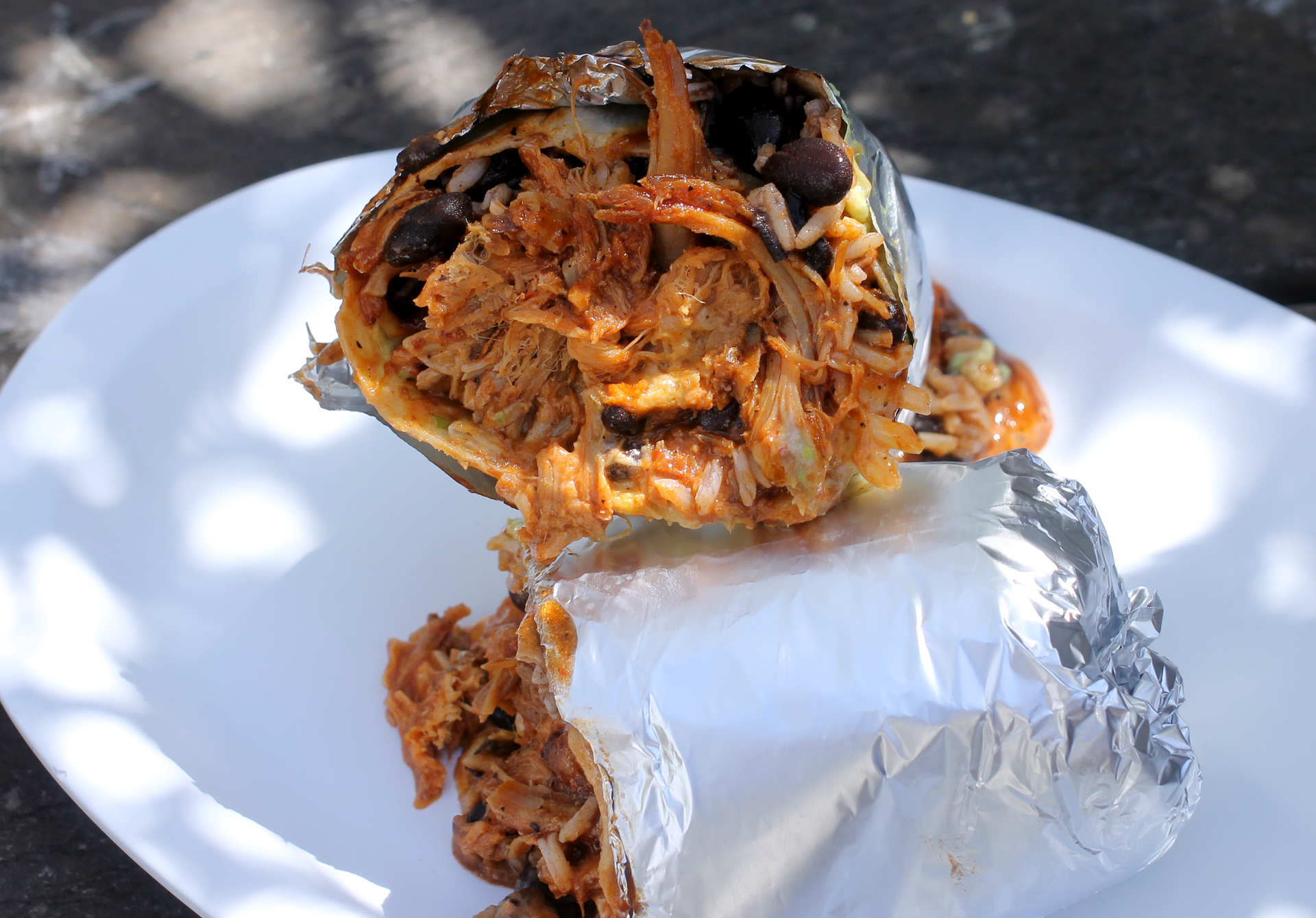 A chile Colorado burrito with pork and black beans from La Mission.
