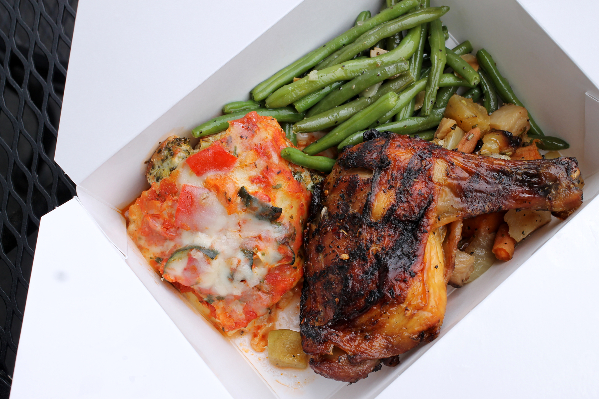 Vegetable lasagna, green beans almondine, roasted root vegetables, and jerk chicken from Piedmont Grocery.