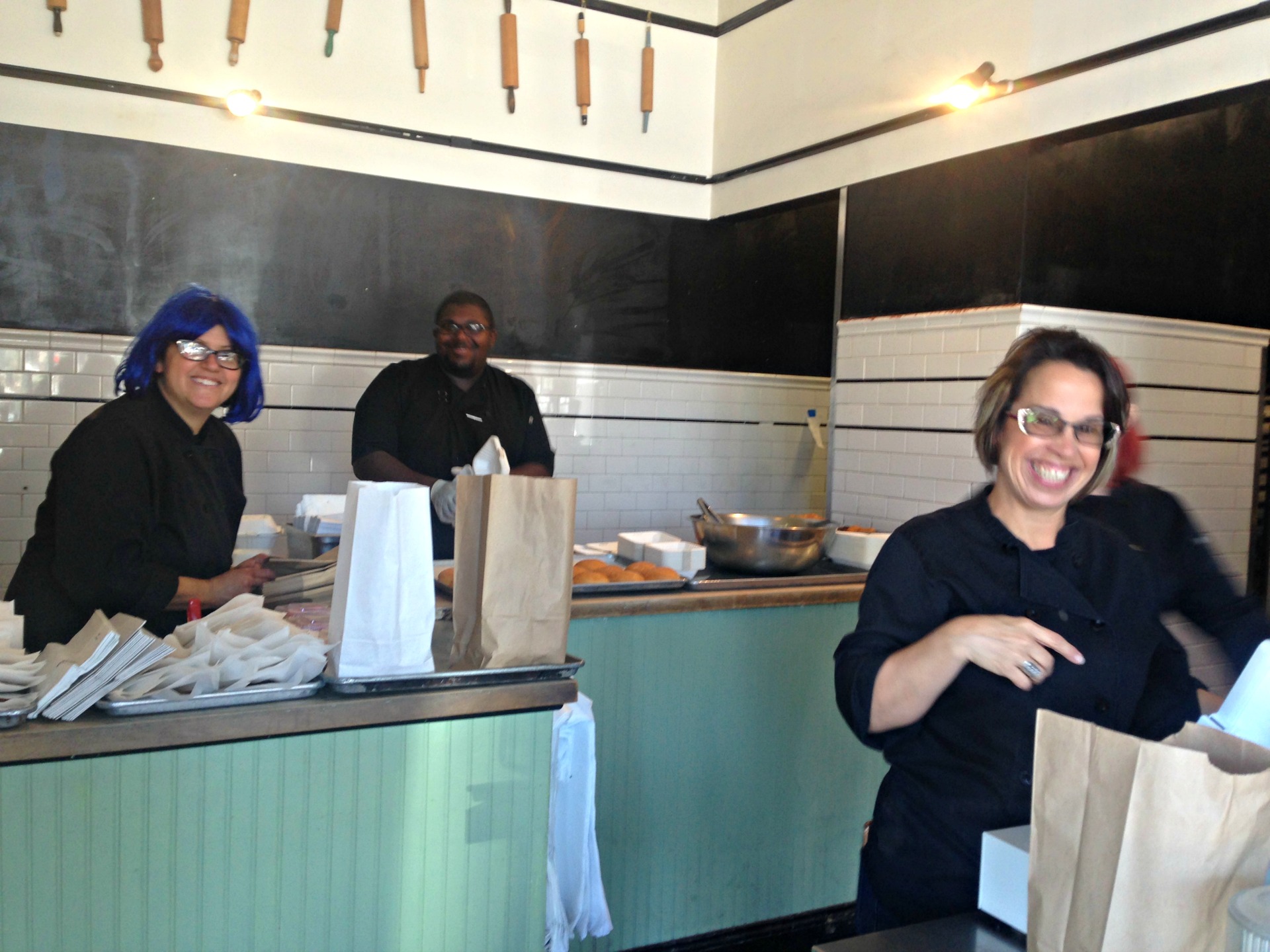 Bakesale Betty's owner blue-wigged Alison Barakat and cheerful workers.