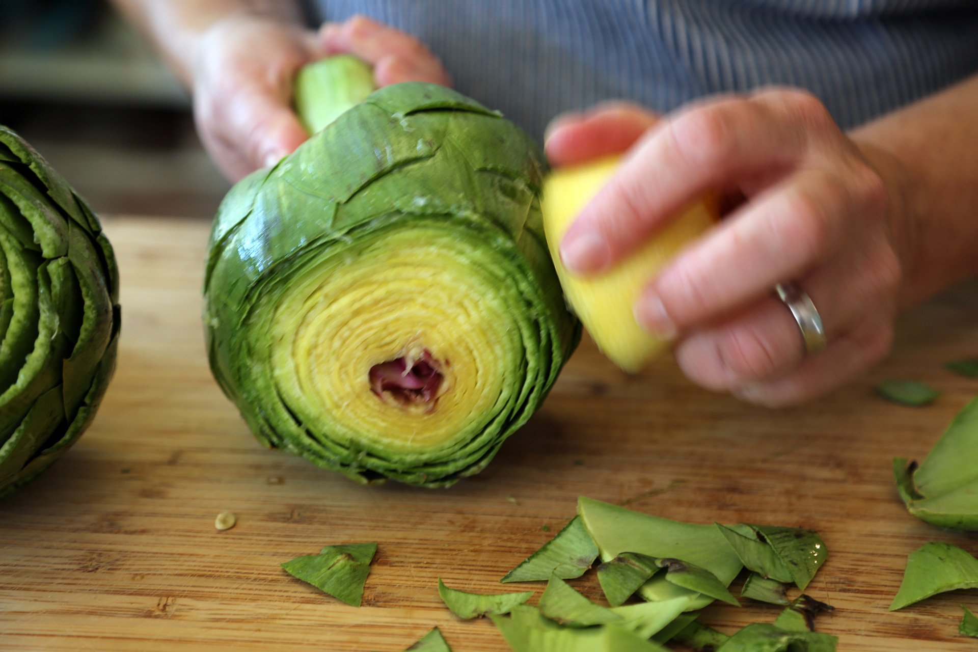 As you trim the artichoke, rub the cut areas with the lemon.