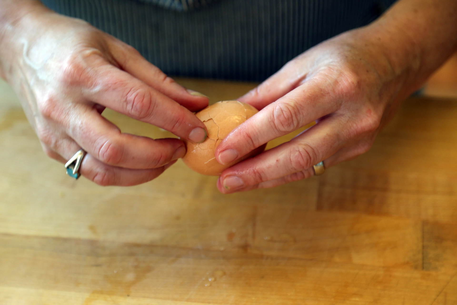 Gently crack the egg shells, then peel.