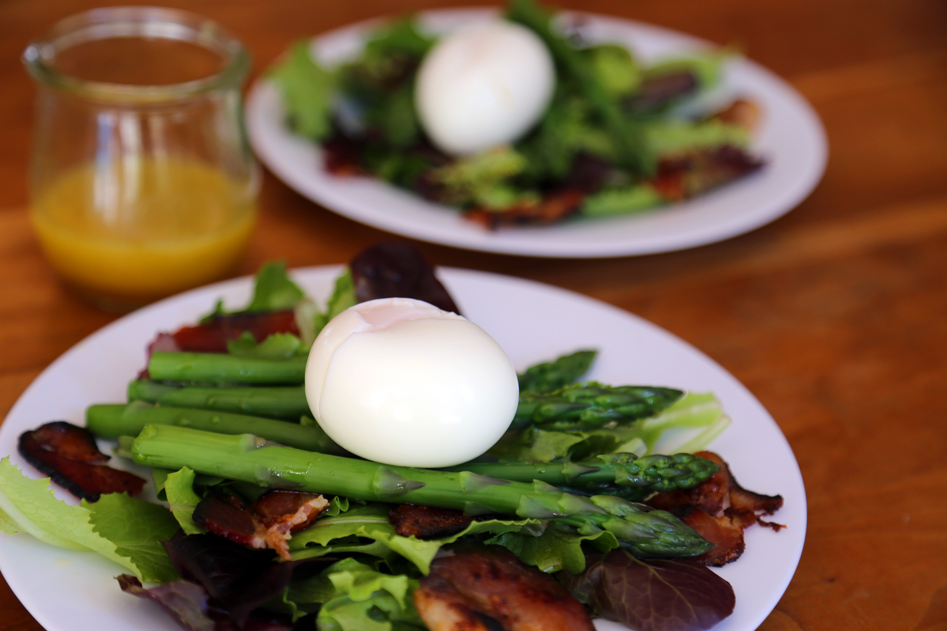 Toss to coat with vinaigrette, then divide between individual plates. Place an egg on each salad.