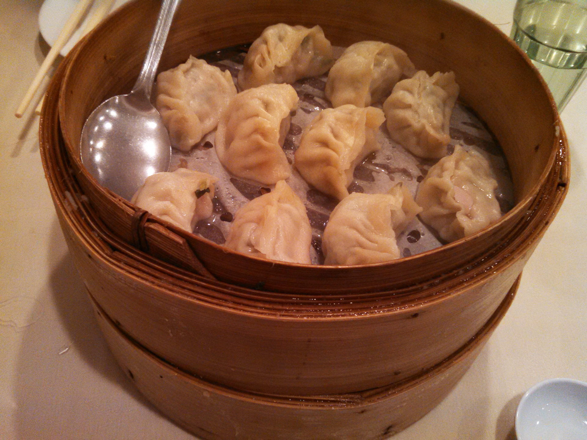 The steamed dumplings are served in their wooden trays