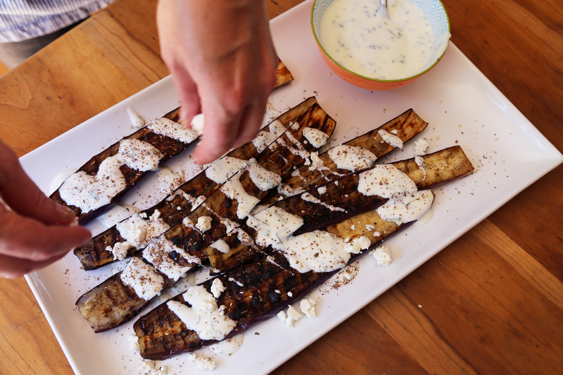 Transfer to a serving plate. Drizzle the eggplant with the yogurt sauce, then sprinkle with the feta and za’atar. Serve.