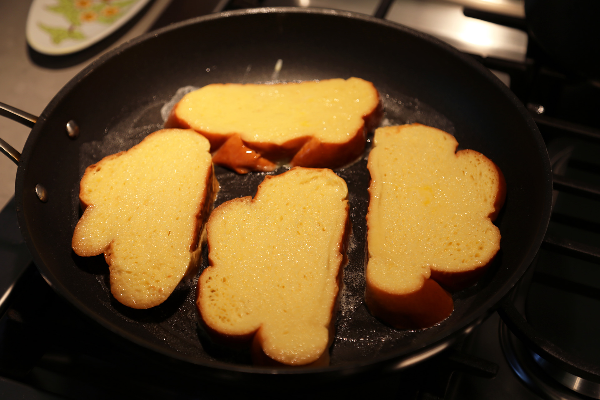 Add as many bread slices as you can easily fit into each pan or on the griddle.