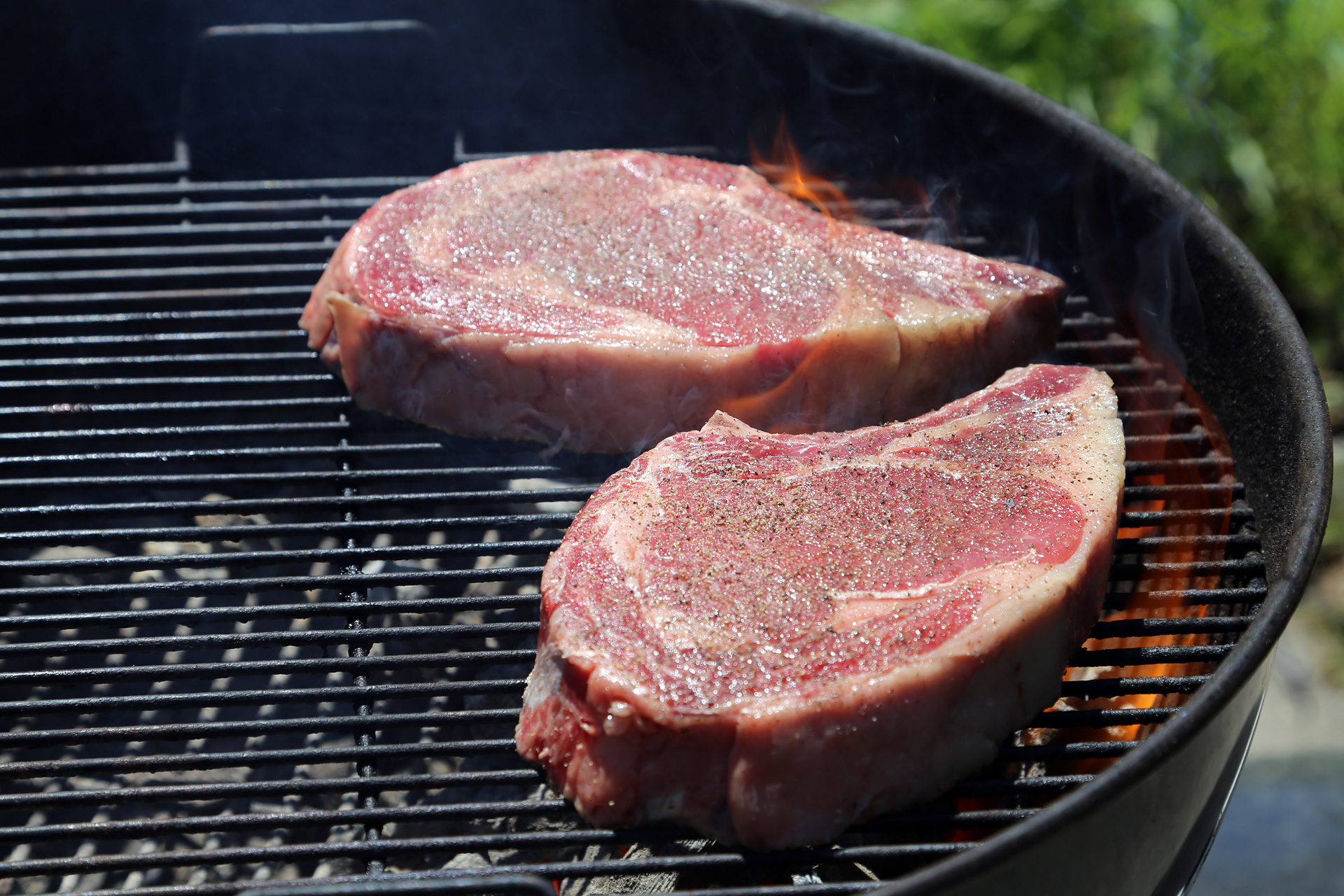 Set up a charcoal grill for high indirect heat. Brush the grill grate with oil. Place steaks on grill over hot area.