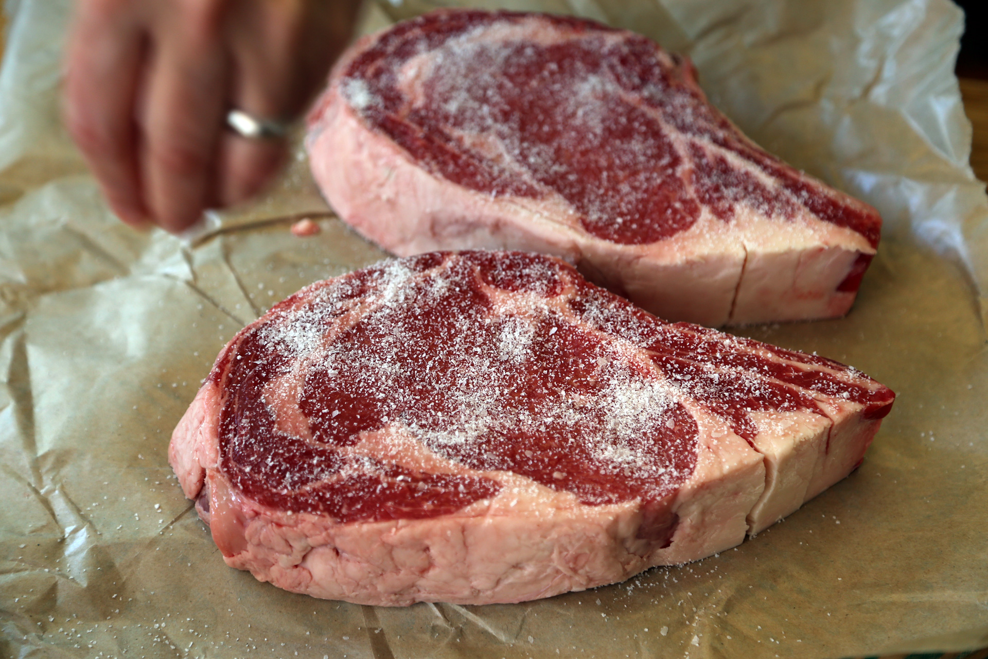 Season simply but liberally. I like to salt my steak ahead of time, at least overnight. You can also salt it and leave it out at room temperature for 45 minutes before grilling.