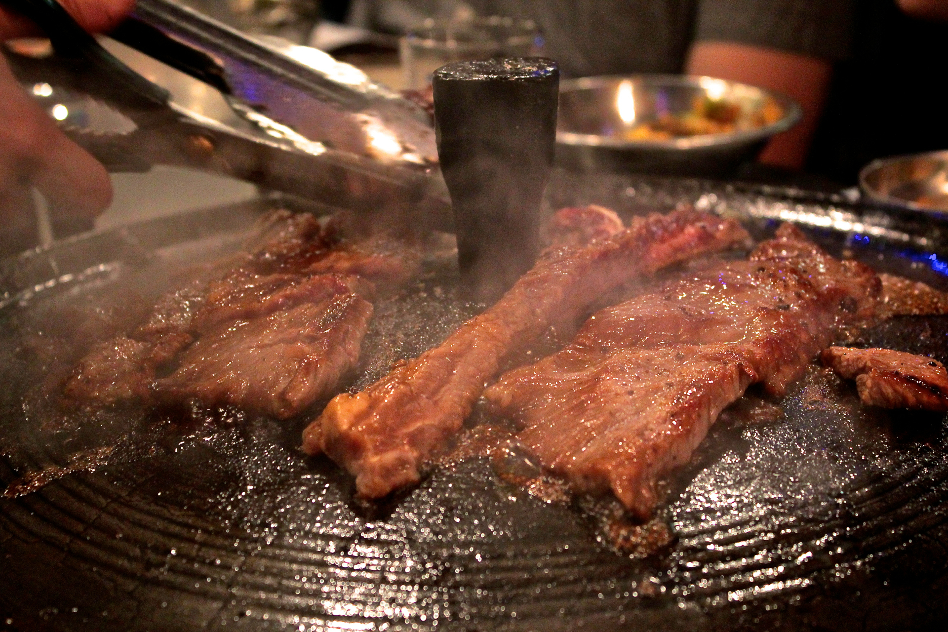 A server cooks boneless prime short rib at Gooyi Gooyi.