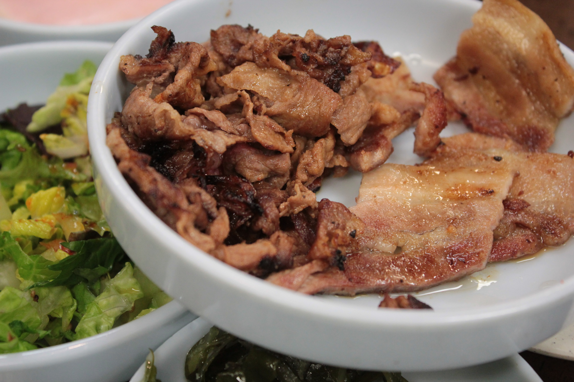 Cooked thinly sliced beef and pork belly.