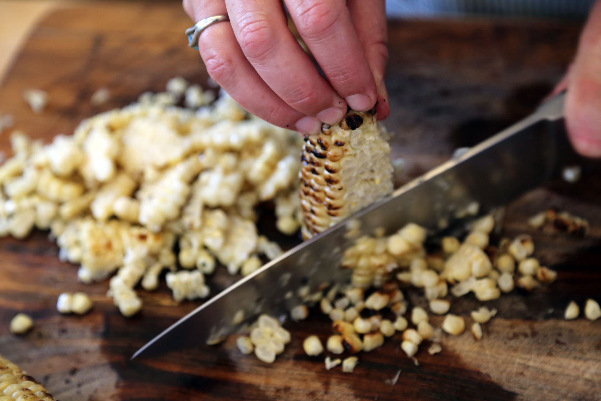 When the corn is cool enough to handle, cut the kernels from the cob using a large, sharp knife.
