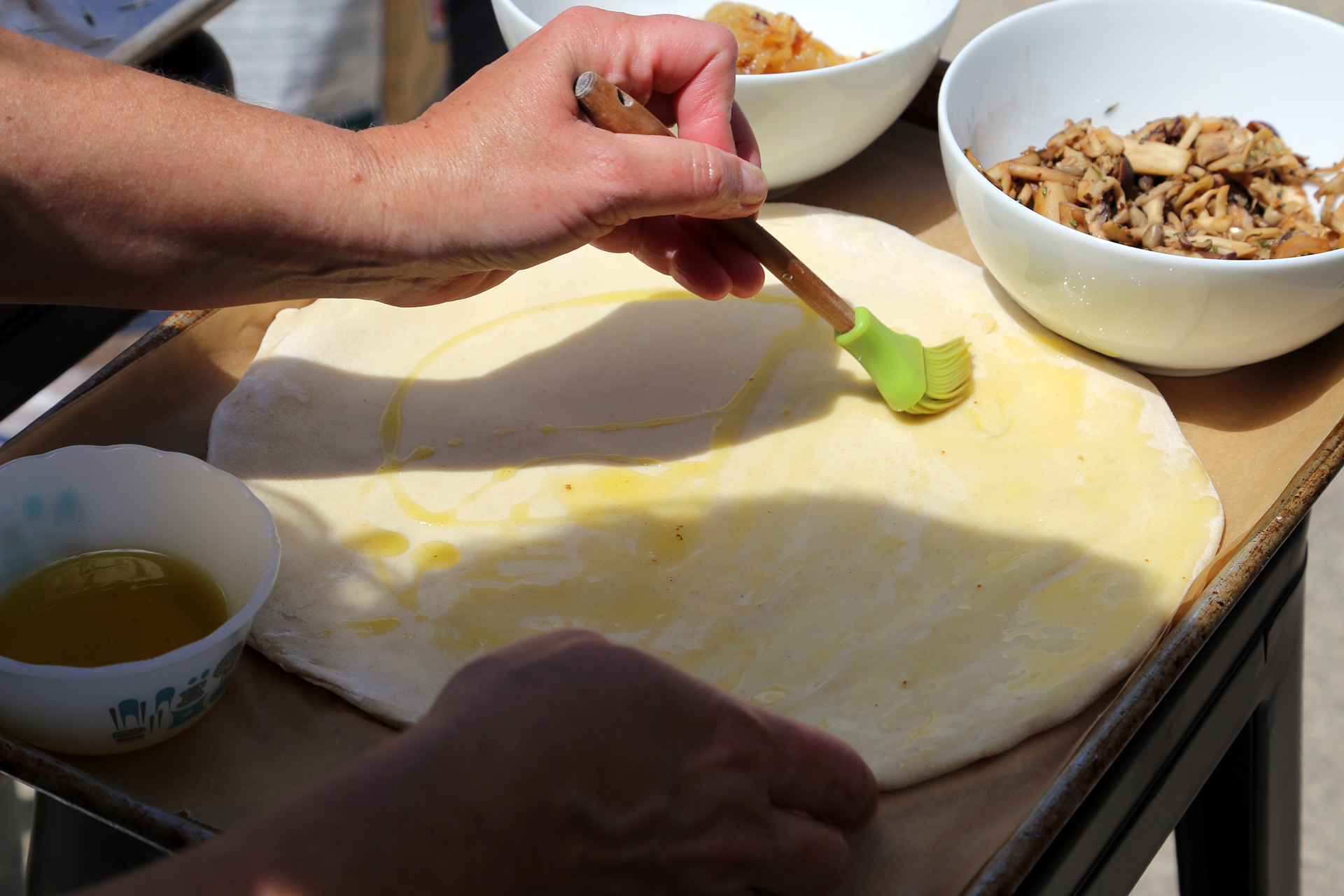 Place each on a parchment-lined baking sheet. For each dough round, brush one side lightly with olive oil.