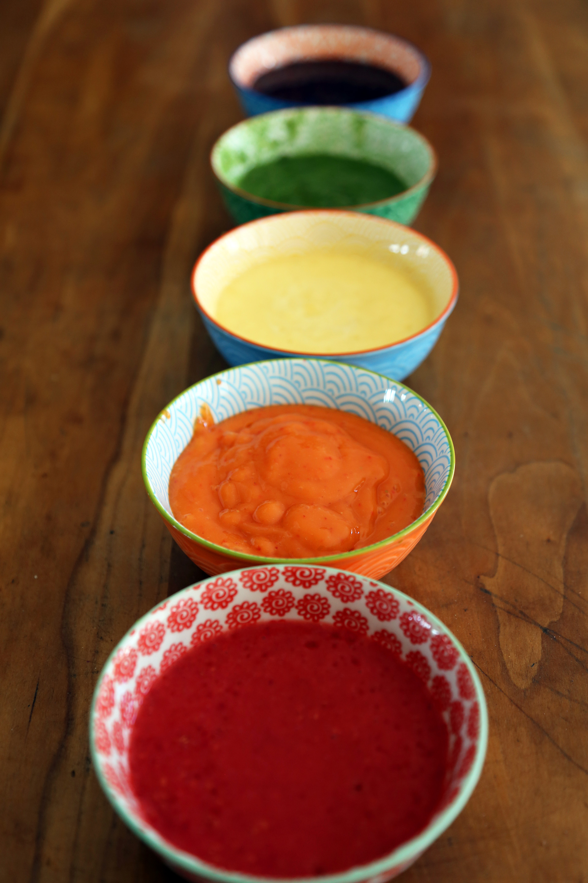Pour each layer of fresh fruity puree into a small bowl.
