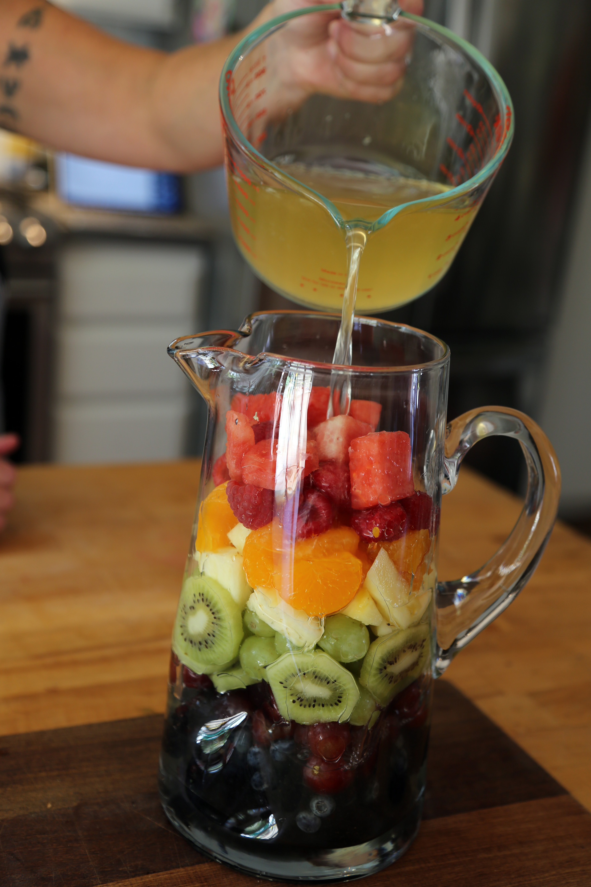 Pour the wine mixture into the pitcher over the fruit.