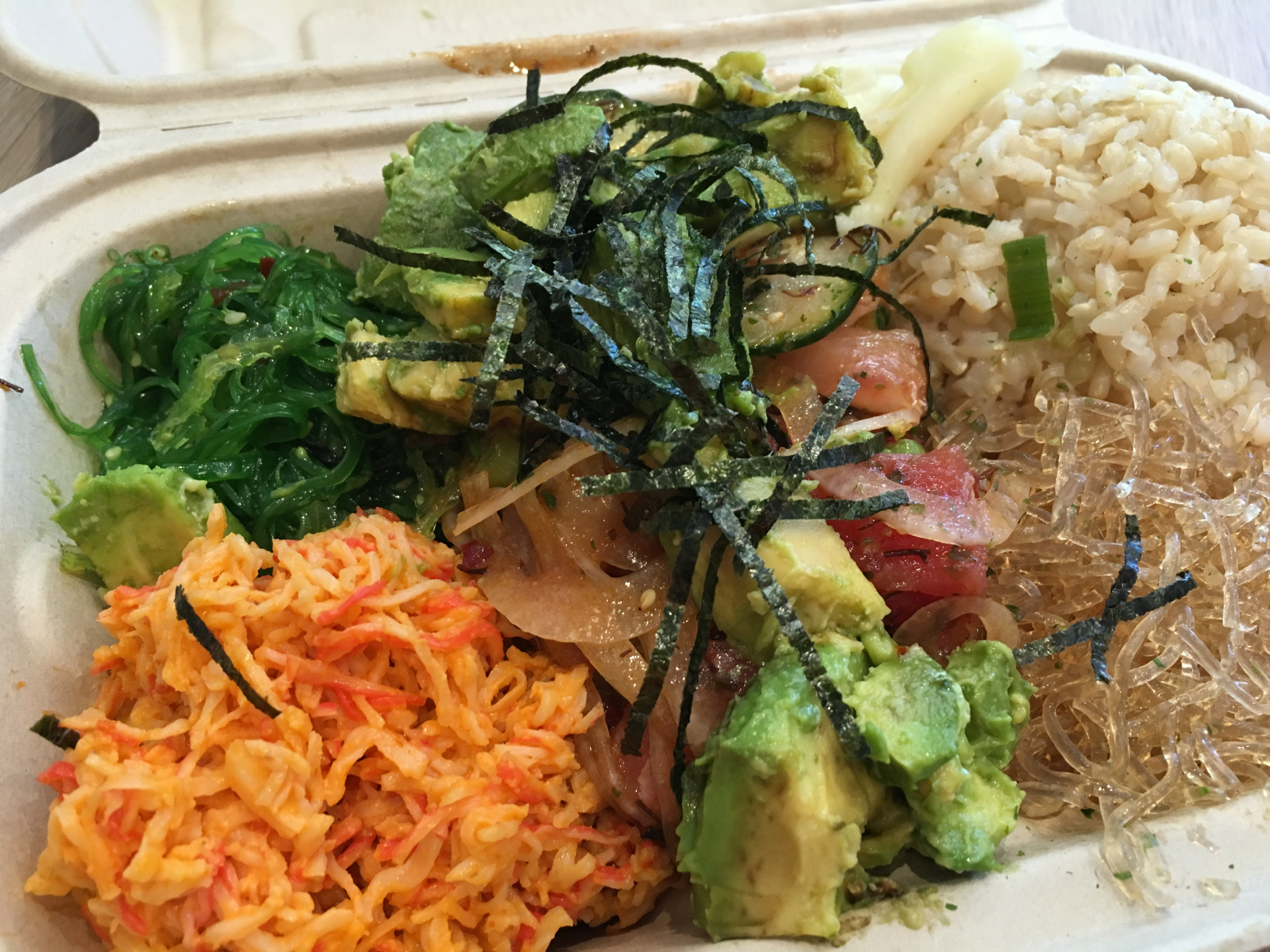 Ahi tuna over kelp noodles and brown rice with spicy crab salad and seaweed salad.