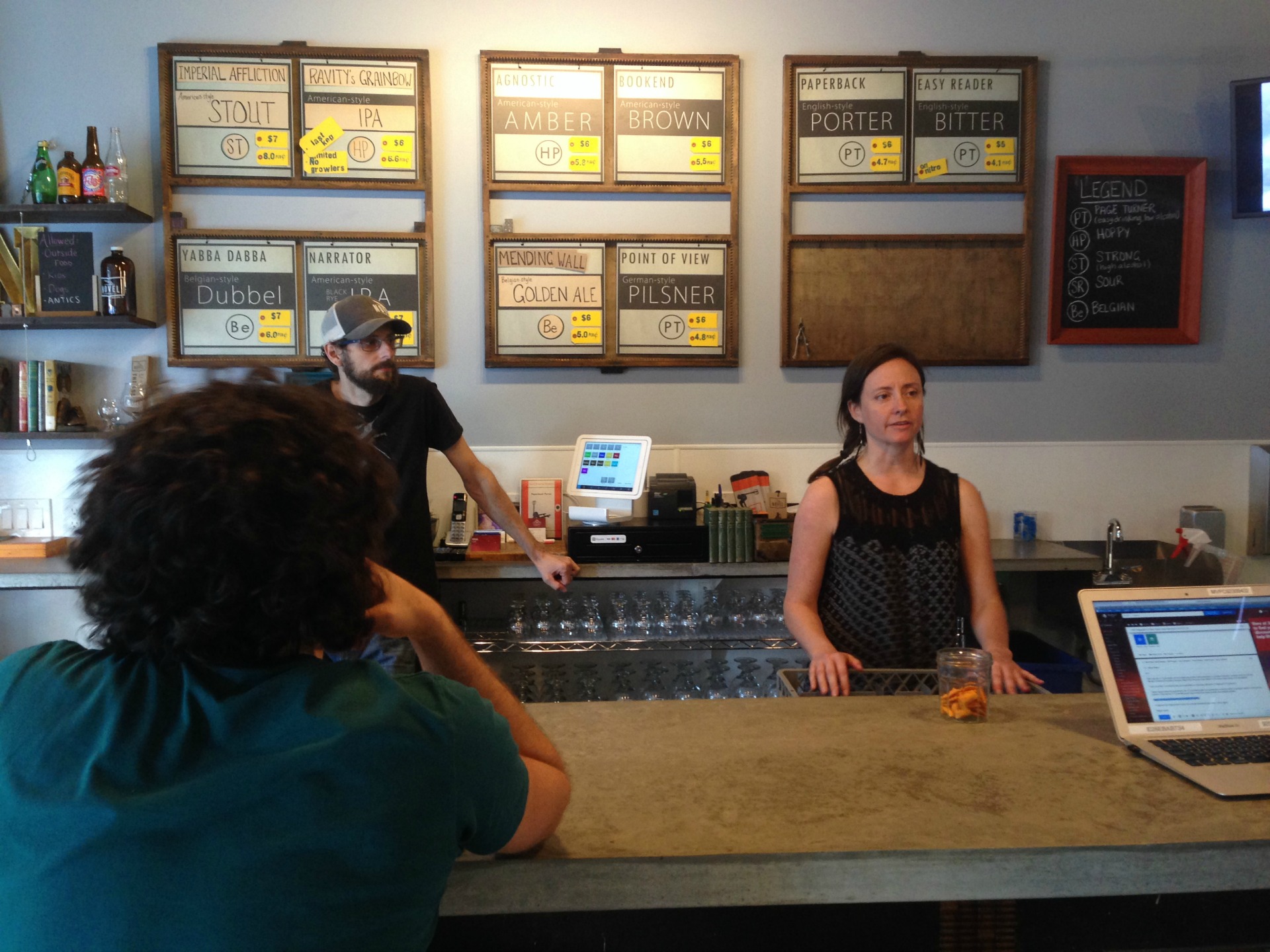 Novel Brewing owners Brian Koloszyc and Teresa Tamburello working the bar.