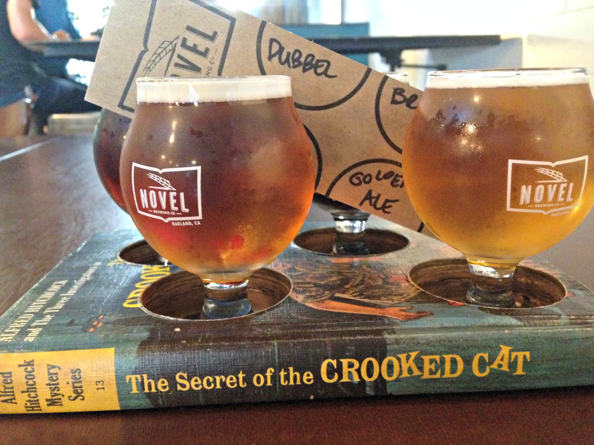A beer sampler in a hollowed-out book from Novel Brewing.