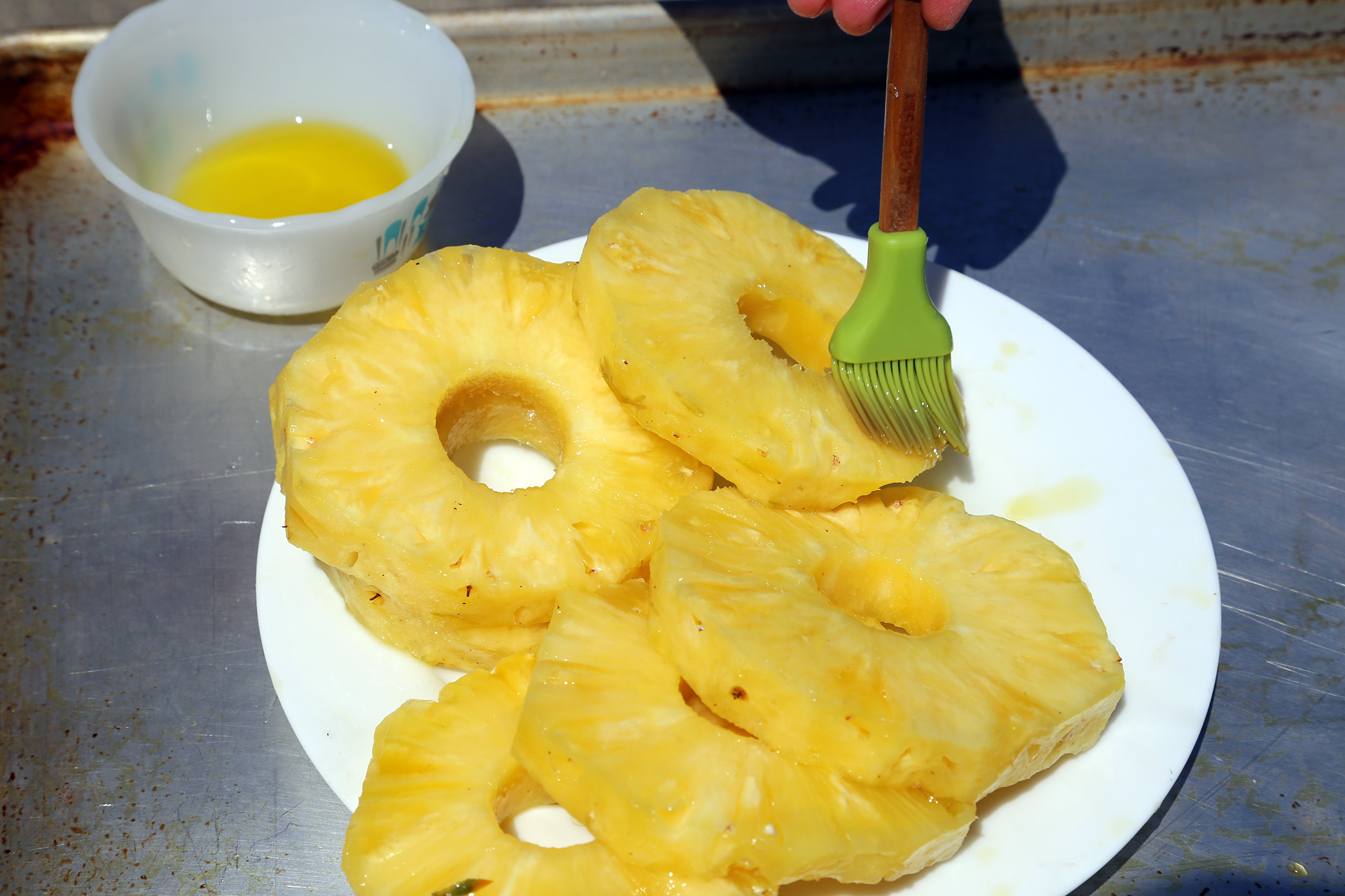 Prep four 1/2-inch-thick slices fresh pineapple, cored. Brush with olive oil for grilling.