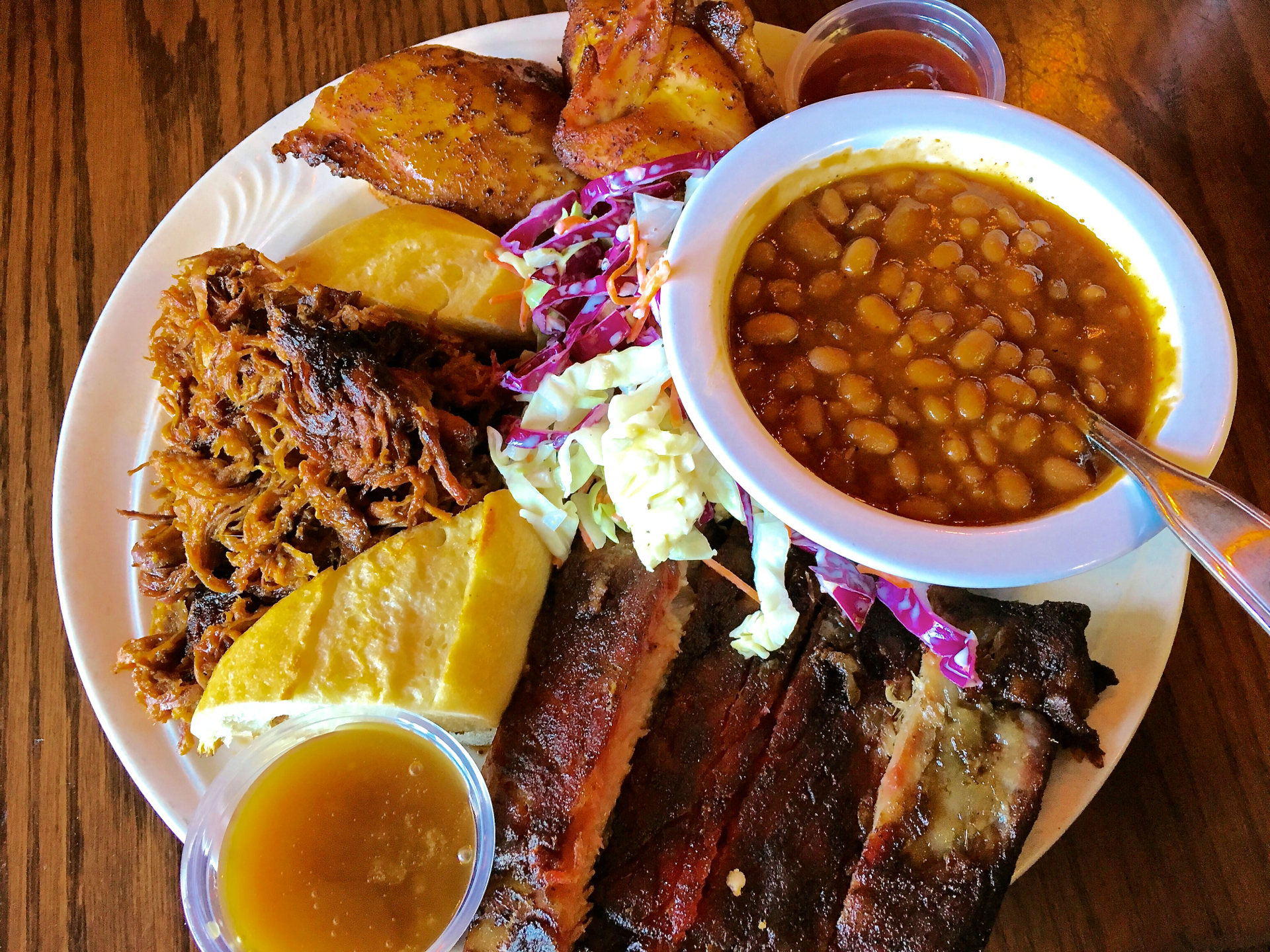 A combination plate with ribs, roasted chicken and pulled pork at The Cats.