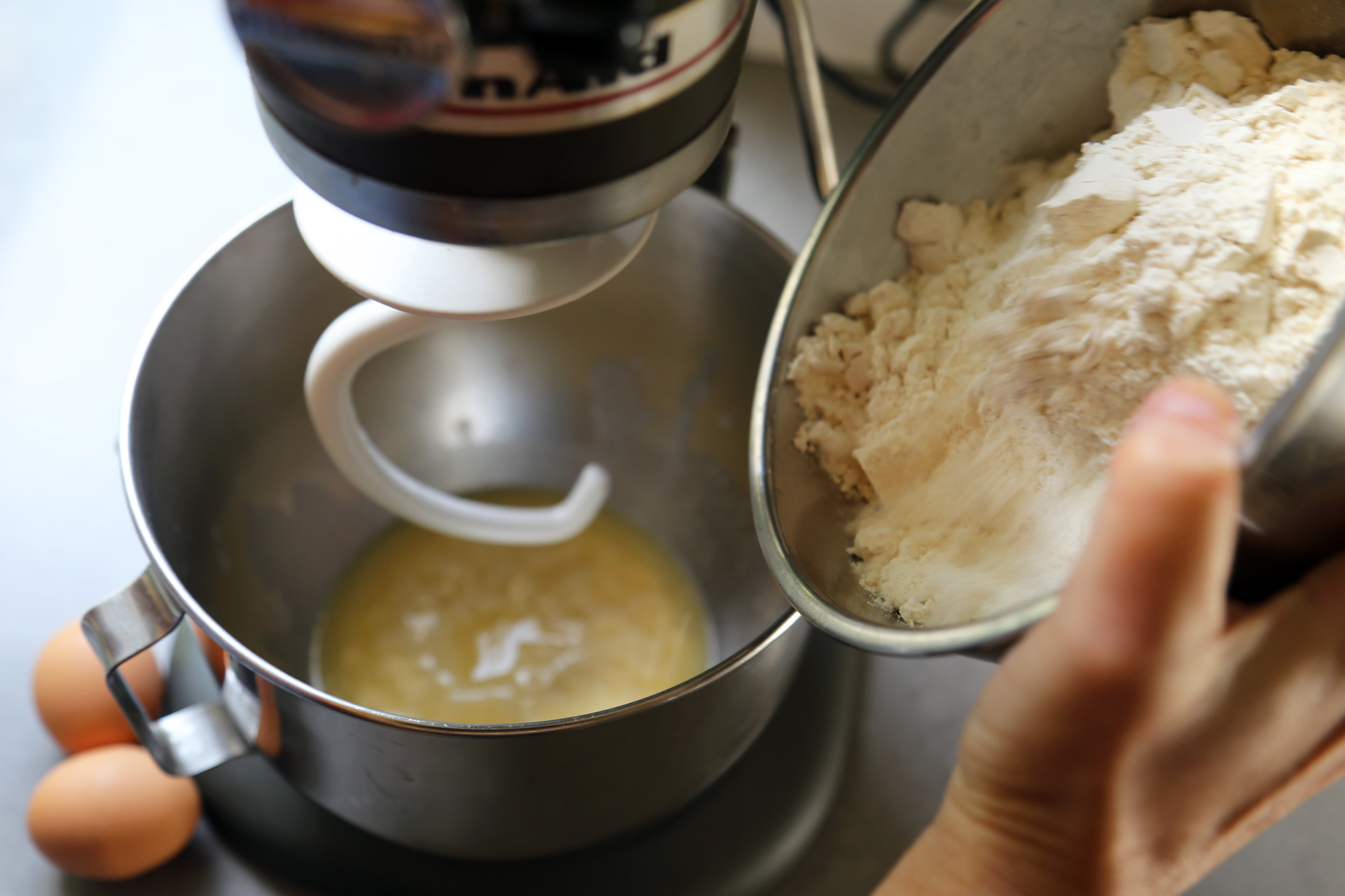 Pour the milk mixture into the stand mixer and stir to combine with the yeast.